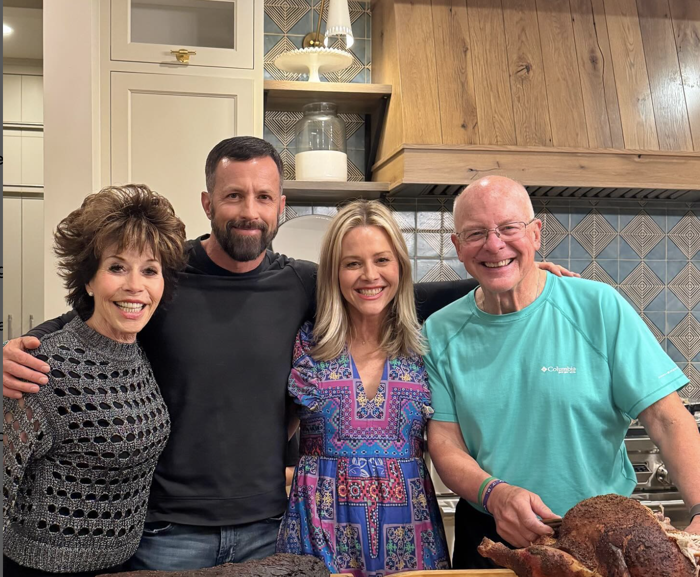 Kristin with her parents and Jeremy in front of a turkey