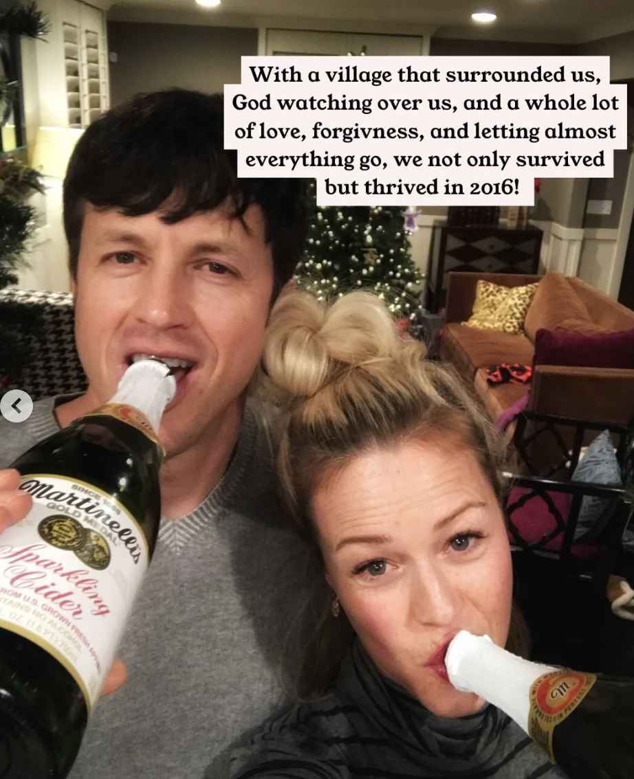 Kristin and Jeremy pose with Martinelli's Sparking Cider bottles