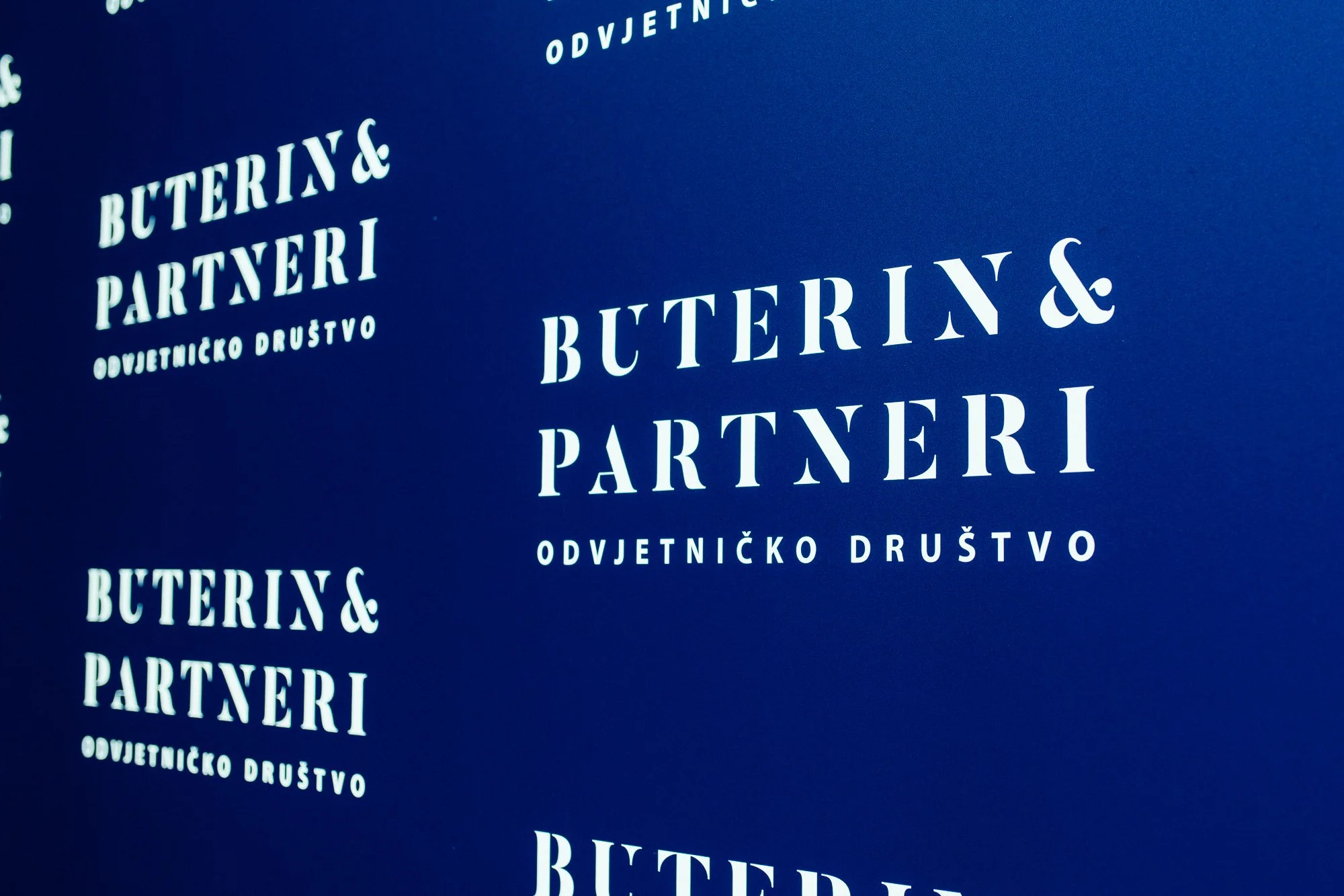 Blue background with white text reading 'BUTERIN& PARTNERI' and 'ODVJETNIČKO DRUŠTVO'.