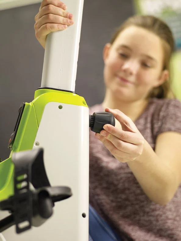 Student adjusting pedal desk height