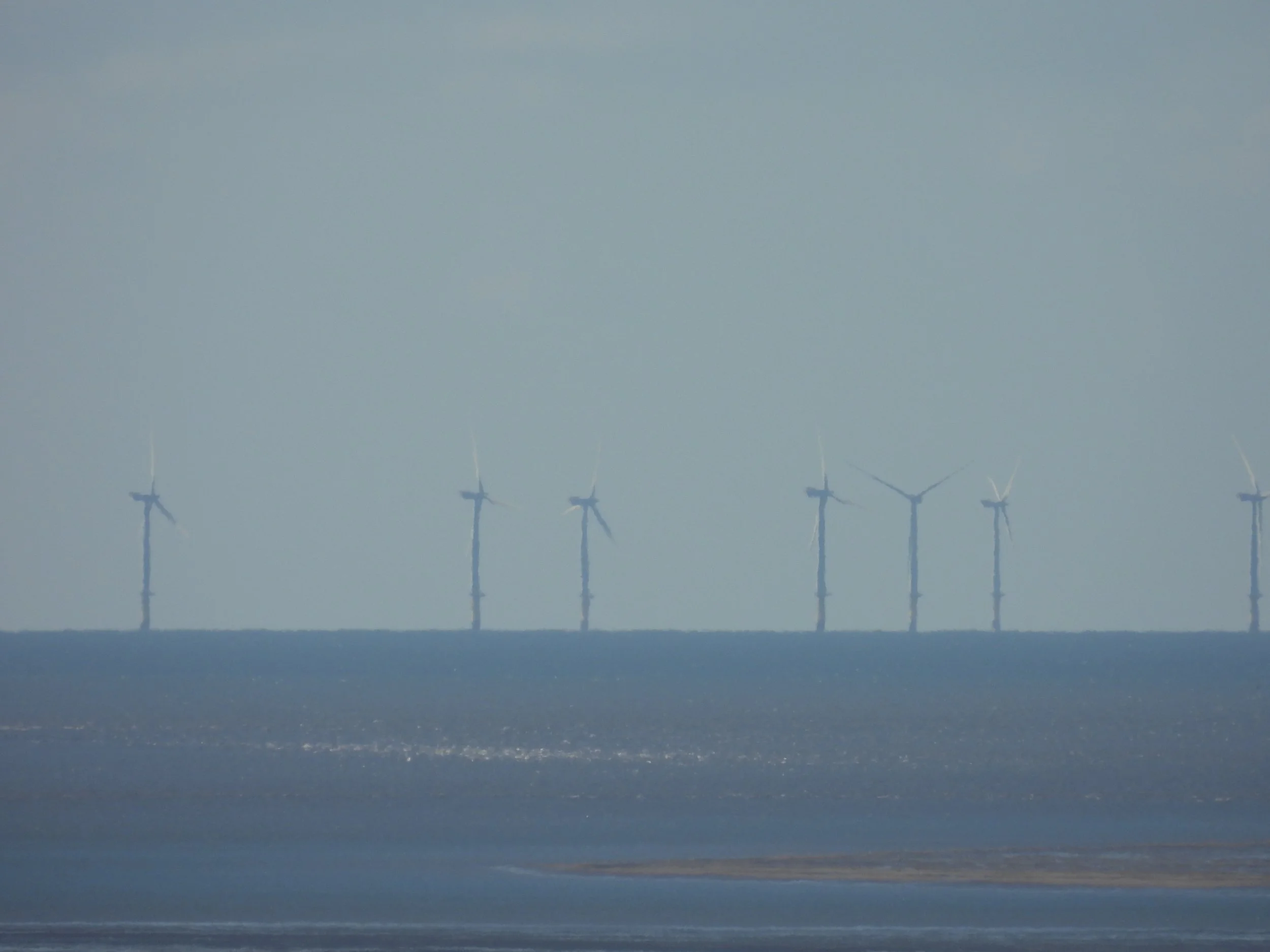 Offshore wind turbines in the ocean.