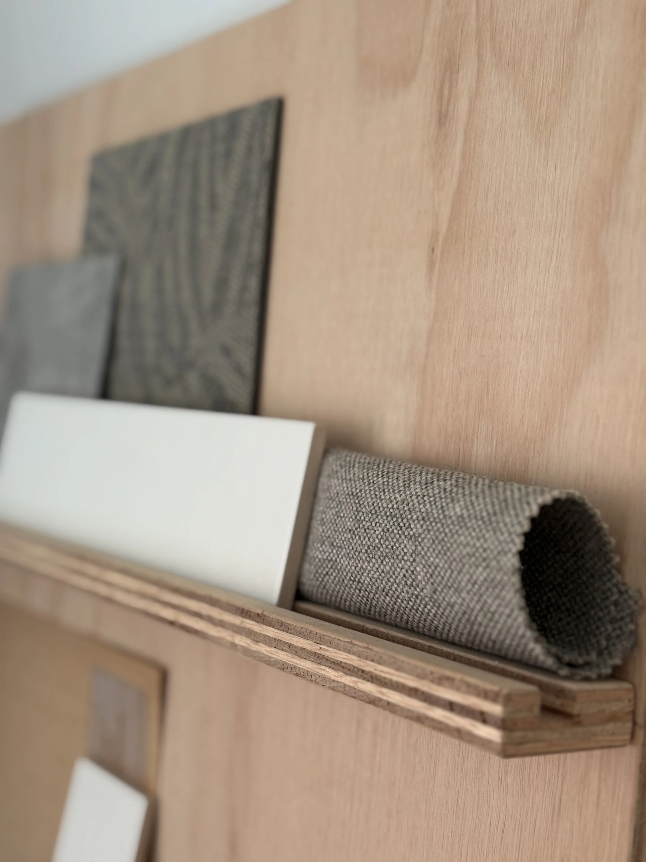 Close-up of a wooden display tray with fabric samples.