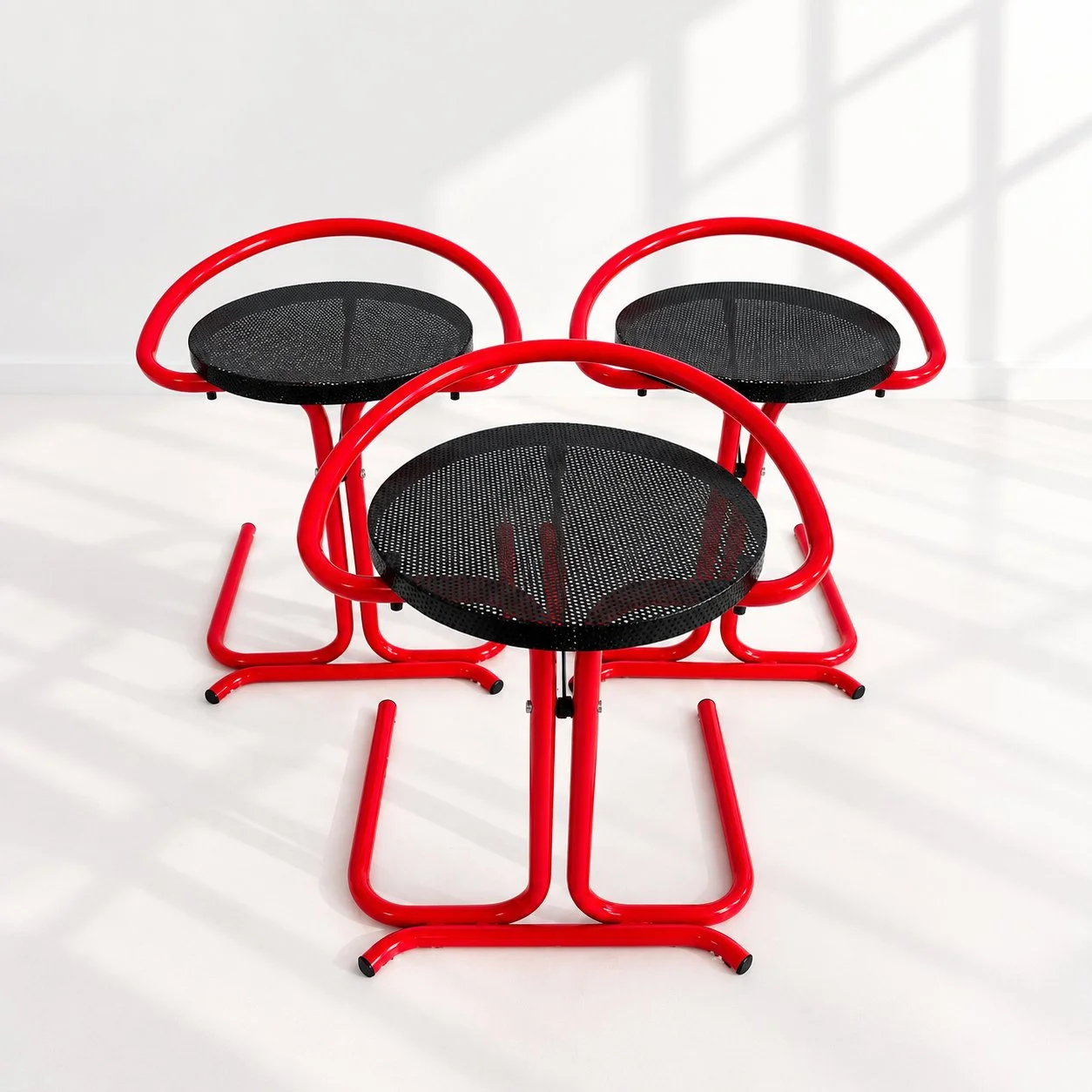 Taburetes postmodernos
A&ntilde;o: D&eacute;cada de los 80
Dise&ntilde;o: Estructura tubular en rojo brillante y negro, con asiento de malla met&aacute;lica perforada. C&iacute;rculos, curvas y l&iacute;neas se cruzan creando una silueta muy gr&aacut