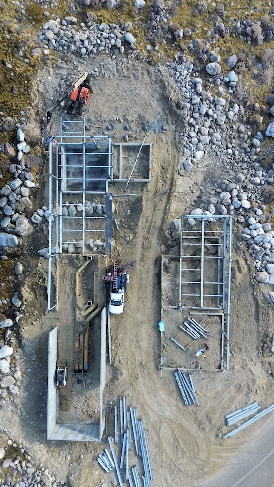 aerial view of the structural steel of a rectangular-shaped home in the desert being installed