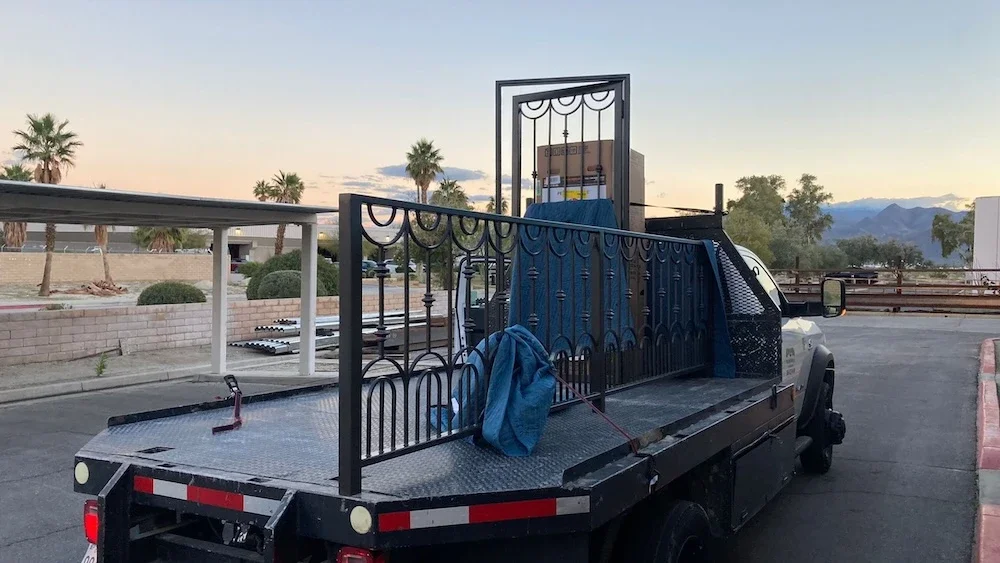 matching ornamental metal railing and door with spindles and curved designs on a work truck ready for delivery