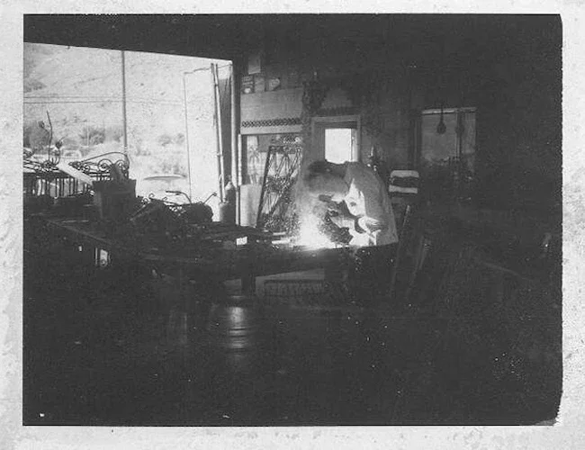 vintage photo of a man welding in an ornamental shop in the 1960s