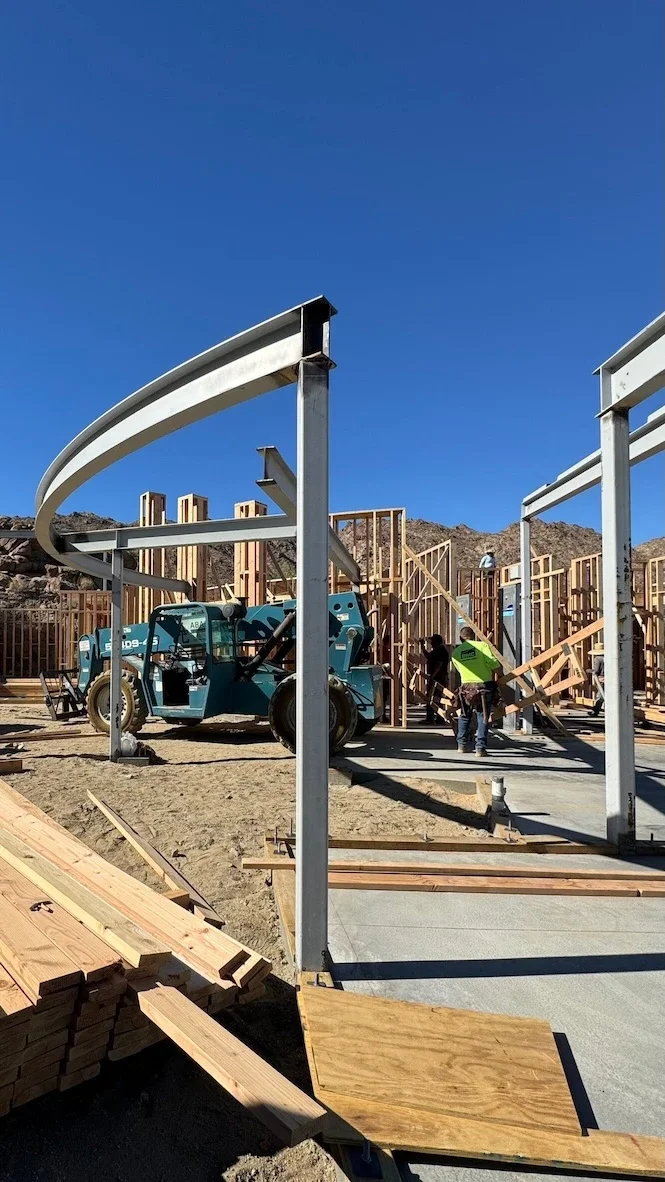 horizontal curved roof beams on a construction site with wood framing and wood planks ready for installation