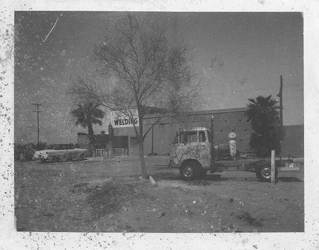 1960s vintage photo of palm springs welding with truck and car out front