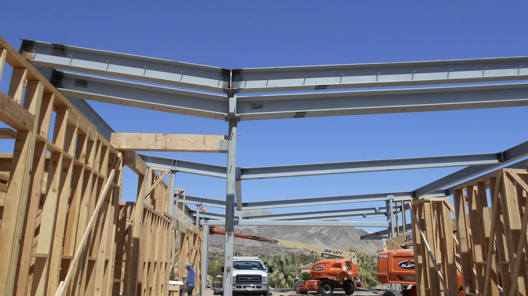 inverted roof beams for a modern home attached to wood framing