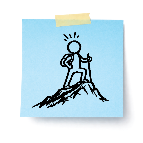 A sticky note with a drawing of a person at the top of a mountain