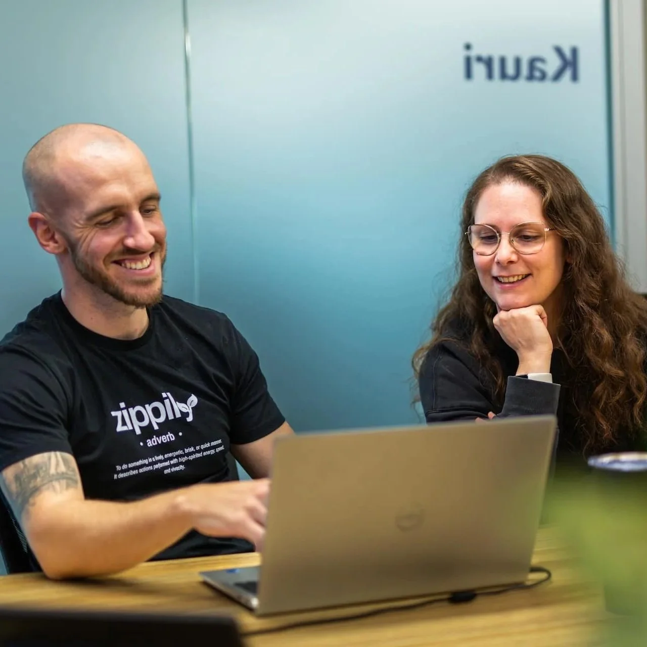 HubSpot training session with team reviewing CRM on a laptop.