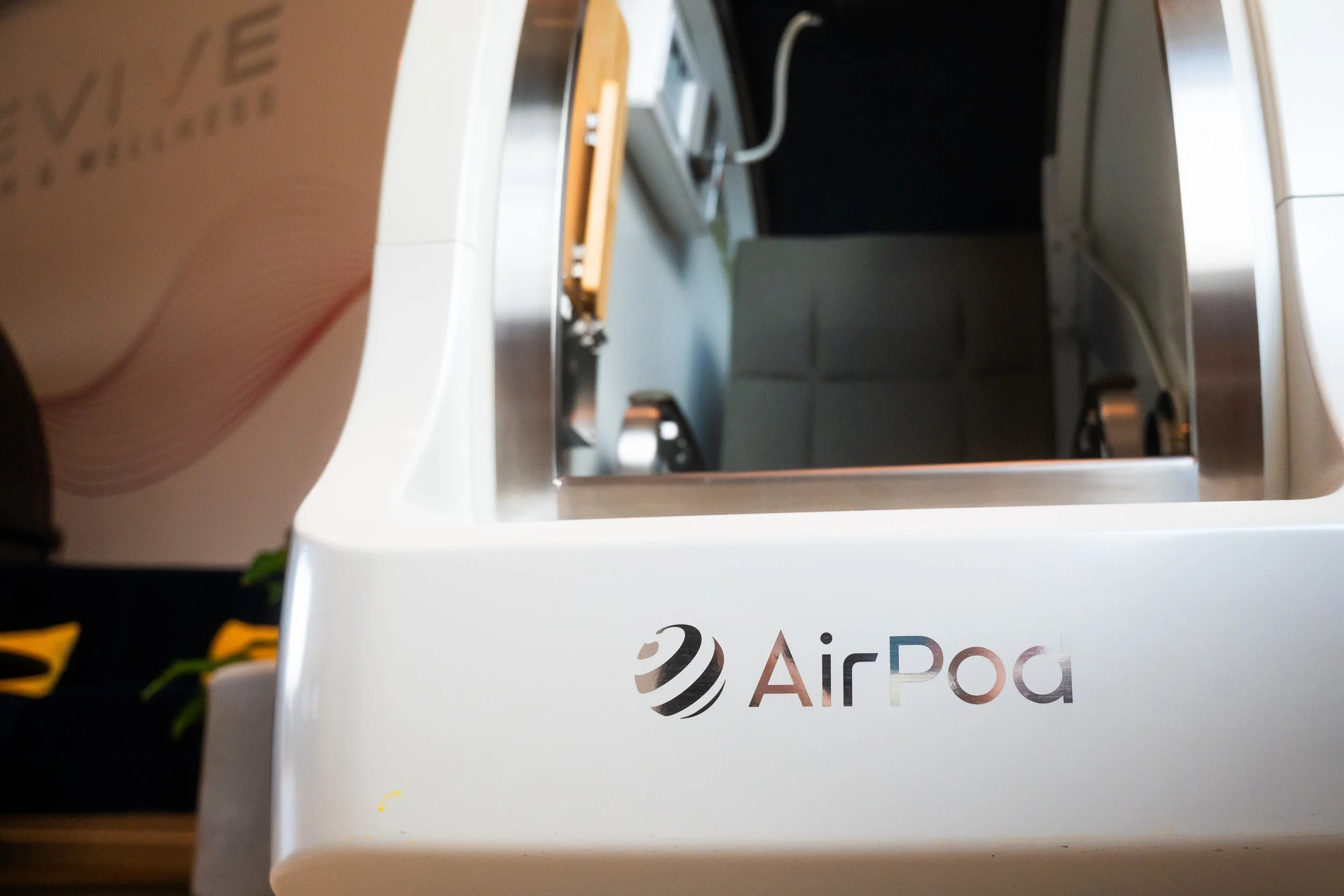 Close-up of a white AirPort device with partially visible logo.