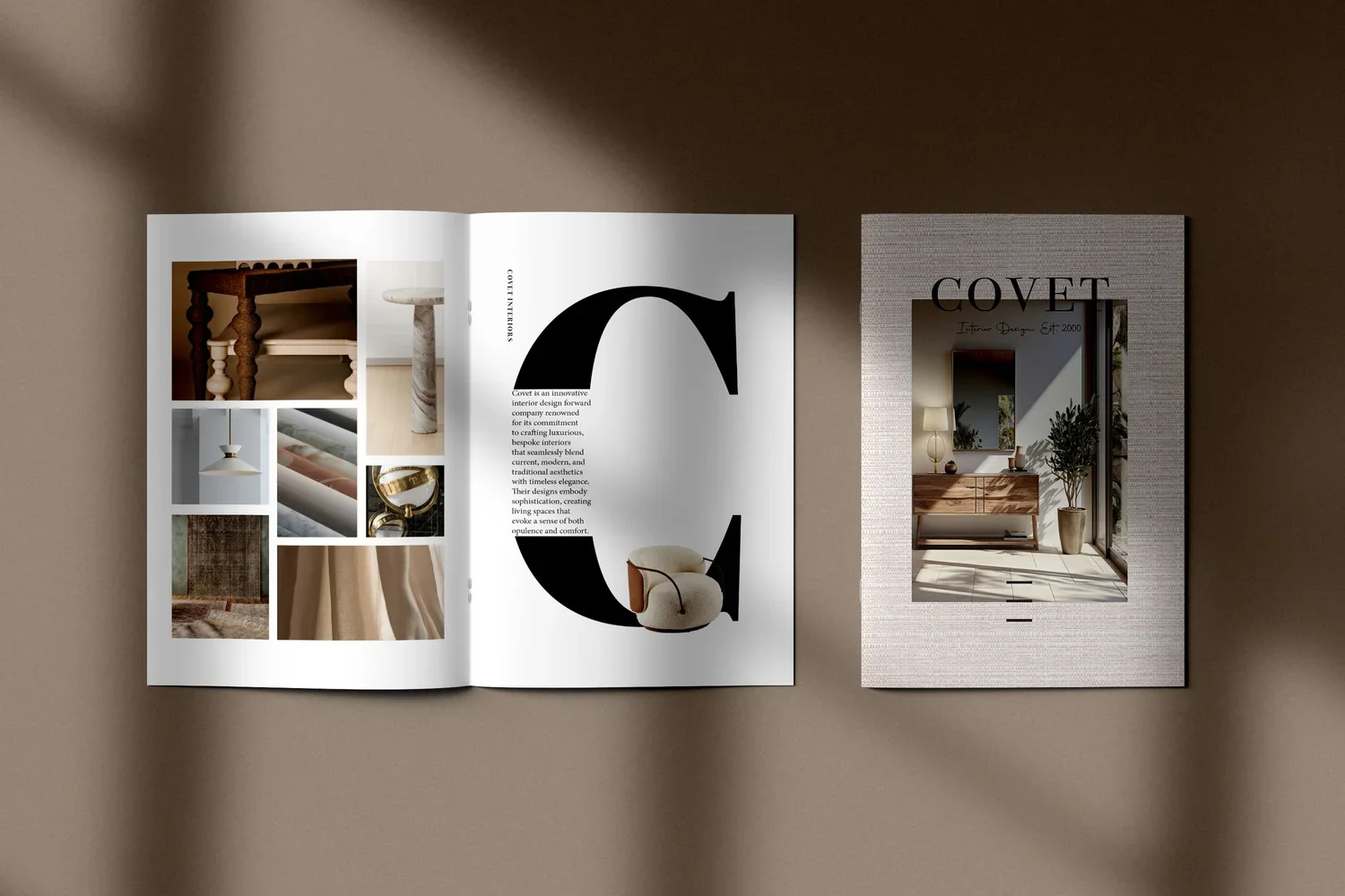 Open interior design magazine with images of furniture and decor, showing a large letter 'C' with text, and a cover with the word 'Covet' and an image of a modernly decorated room.
