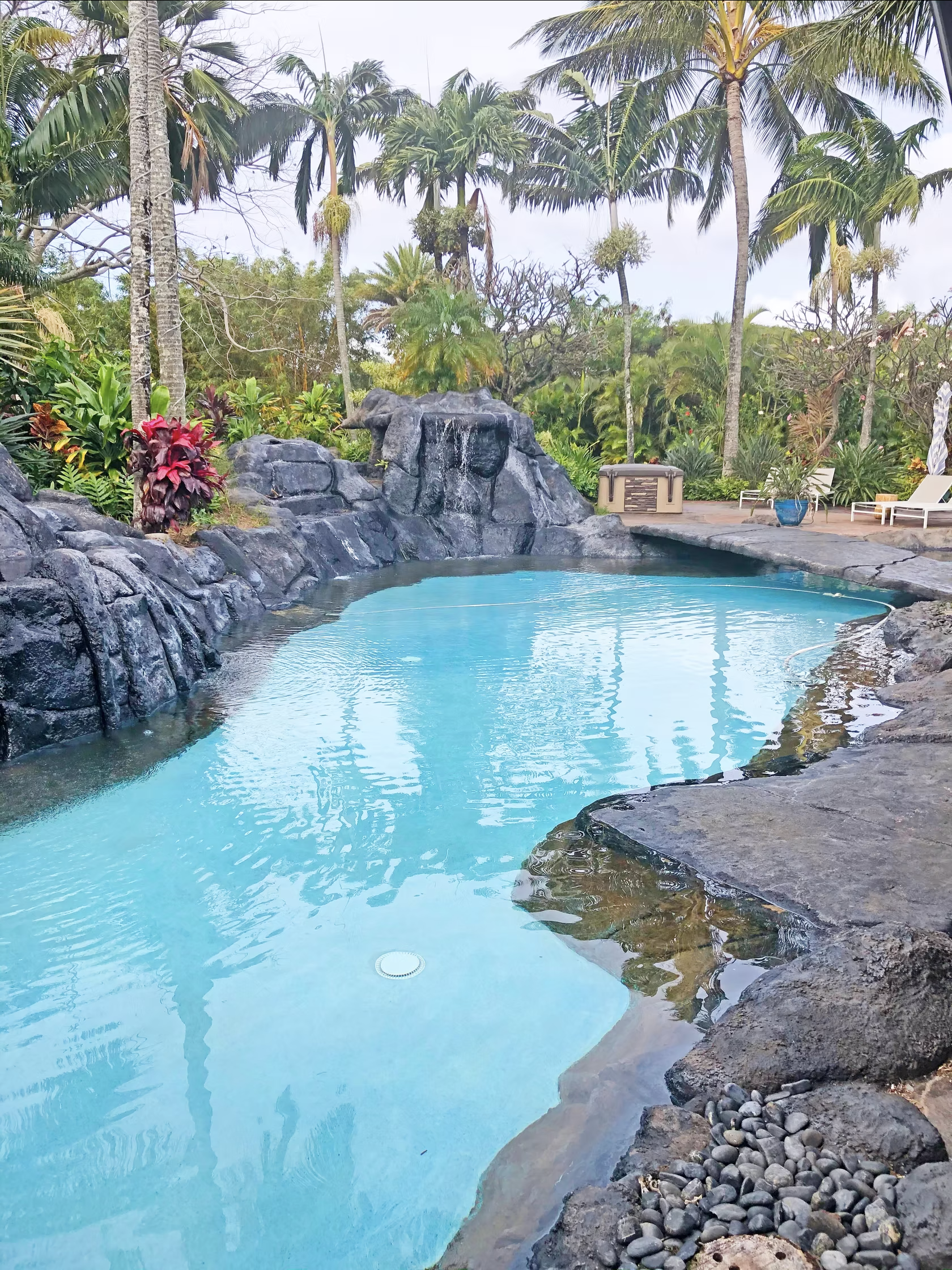 This custom built pool is surrounded by volcanic rock and lush vegetation, making it a slice of Hawaiian paradise.