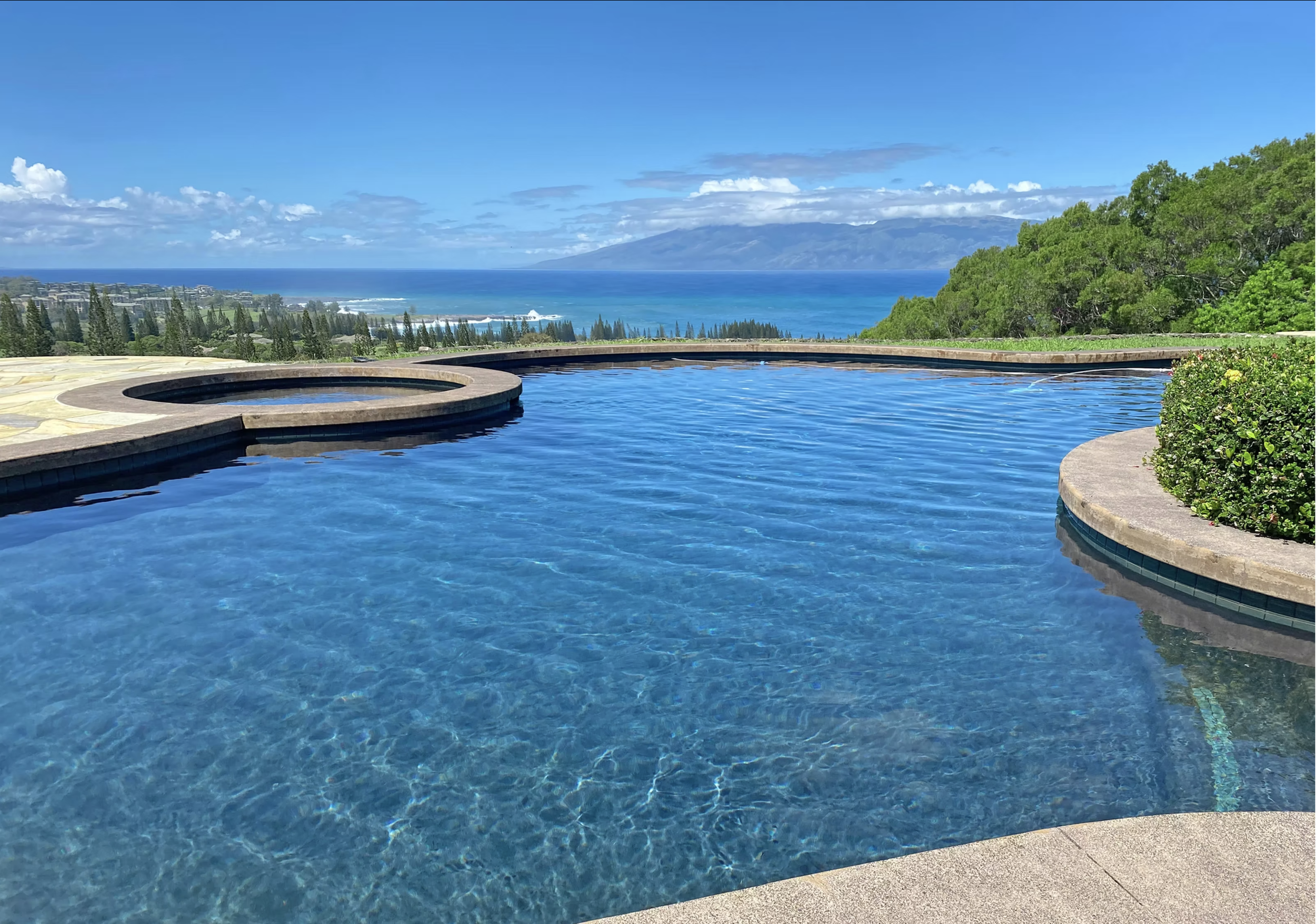 A large pool and spa located on the northern shore of Maui boast a breathtaking view of the island of Molokai.