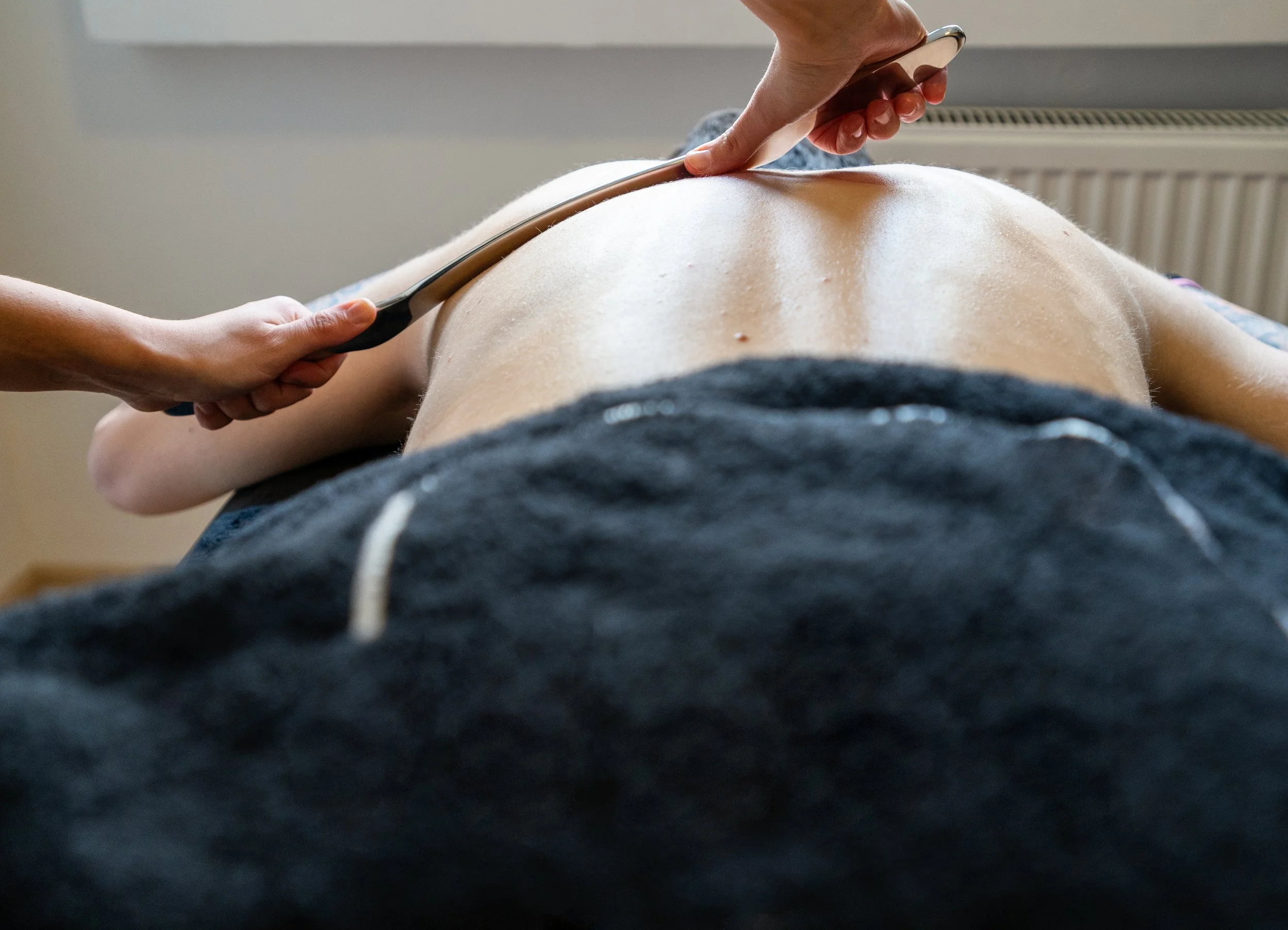 IASTM technique on upper back.