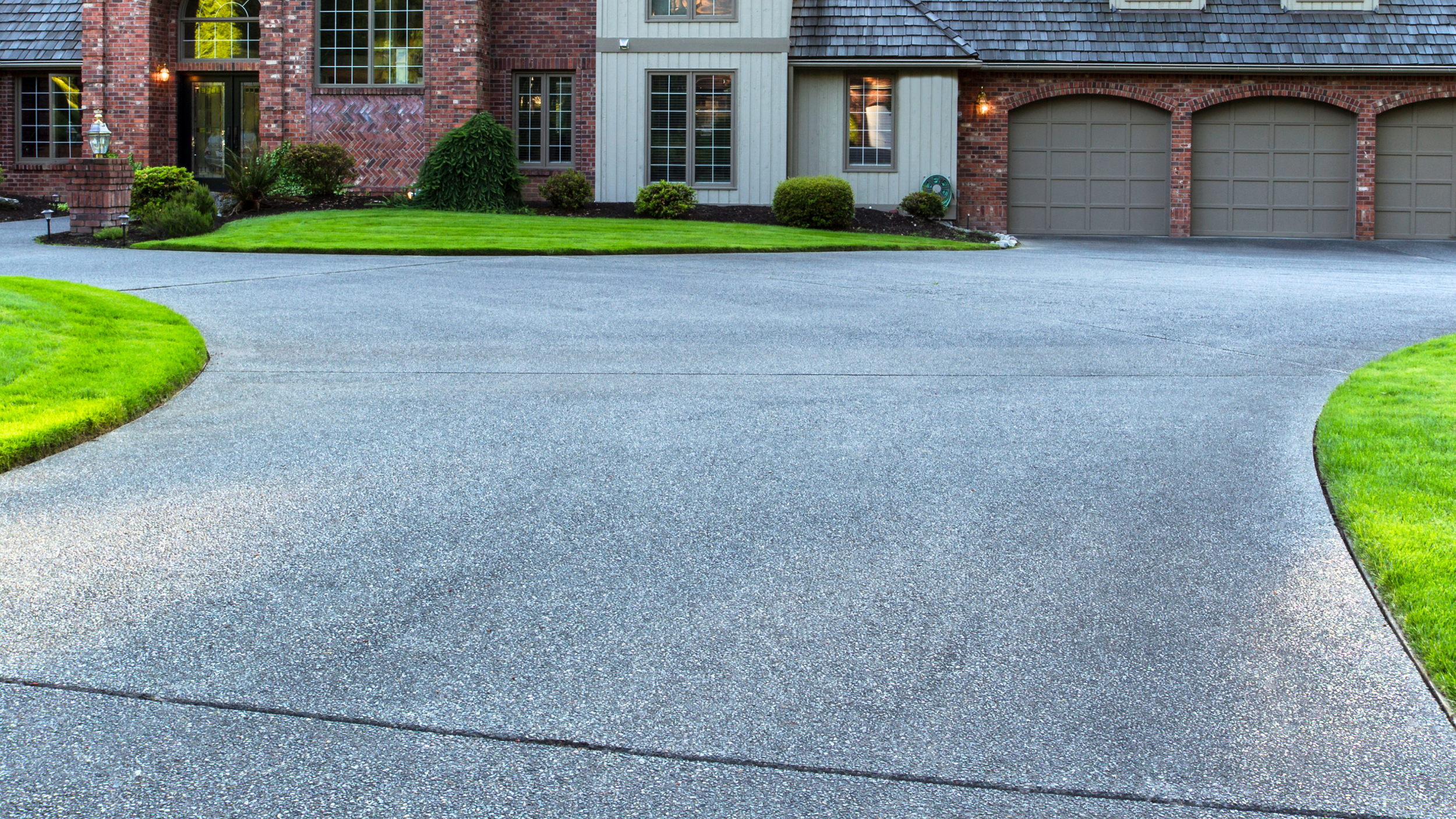Exposed aggregate concrete driveway showing decorative stone texture and slip resistant surface