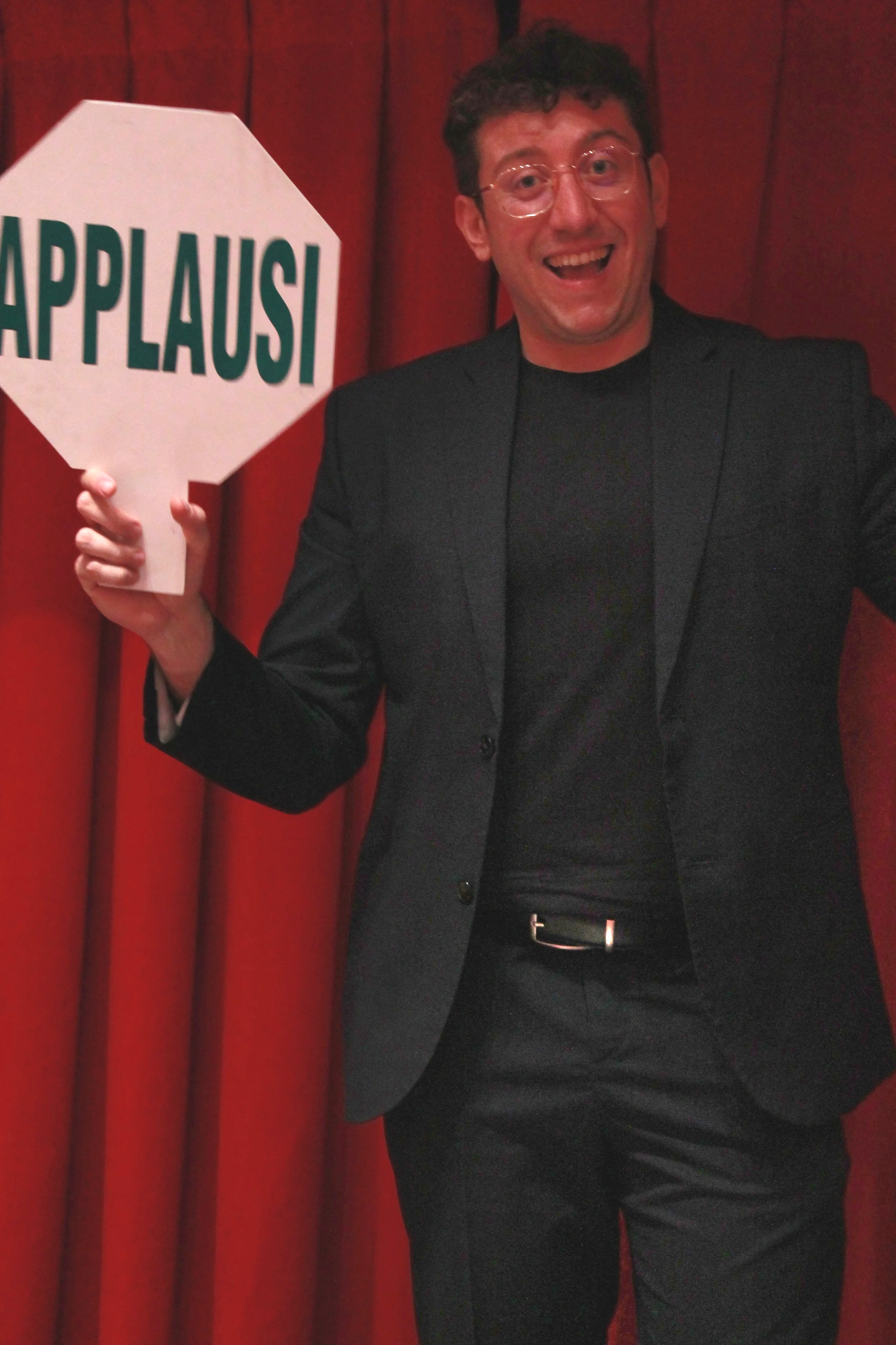 Primo piano di Mago Cofano durante uno spettacolo di magia comica, con espressione teatrale e coinvolgimento del pubblico