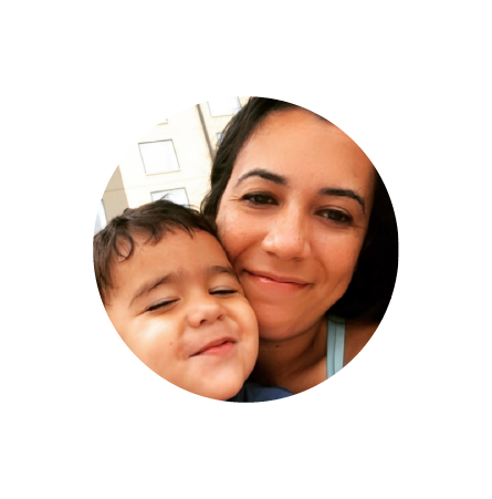 A woman and a young boy smiling and close together in a selfie.