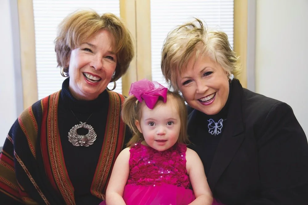 A sweet student with Roz and Little Light House Director, Marcia Mitchell. Roz created the Christmas fundraiser ornaments she and the director are wearing.