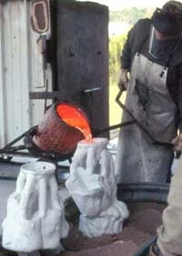 Foundry artisan pouring molten bronze, casting a Rosalind Cook Sculpture.
