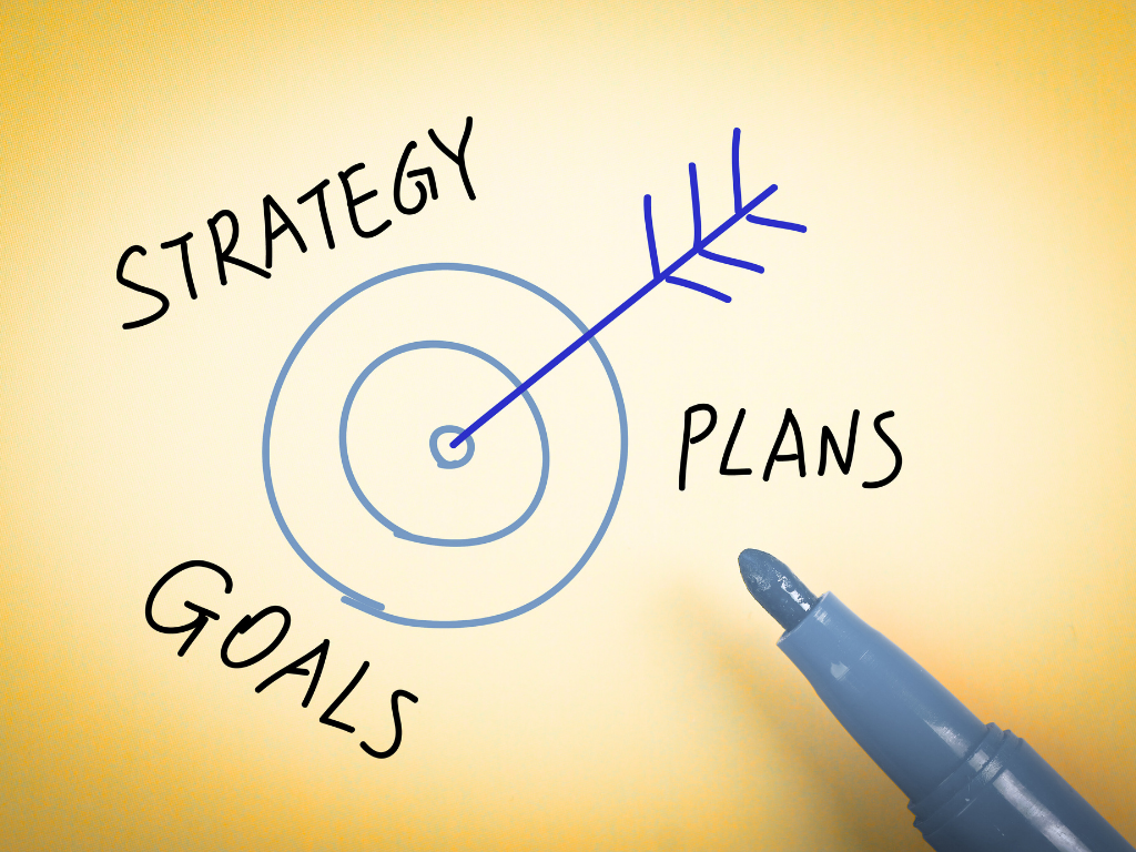 Illustration of a target with an arrow labeled "Strategy," "Goals," and "Plans" with a pen on a yellow background.