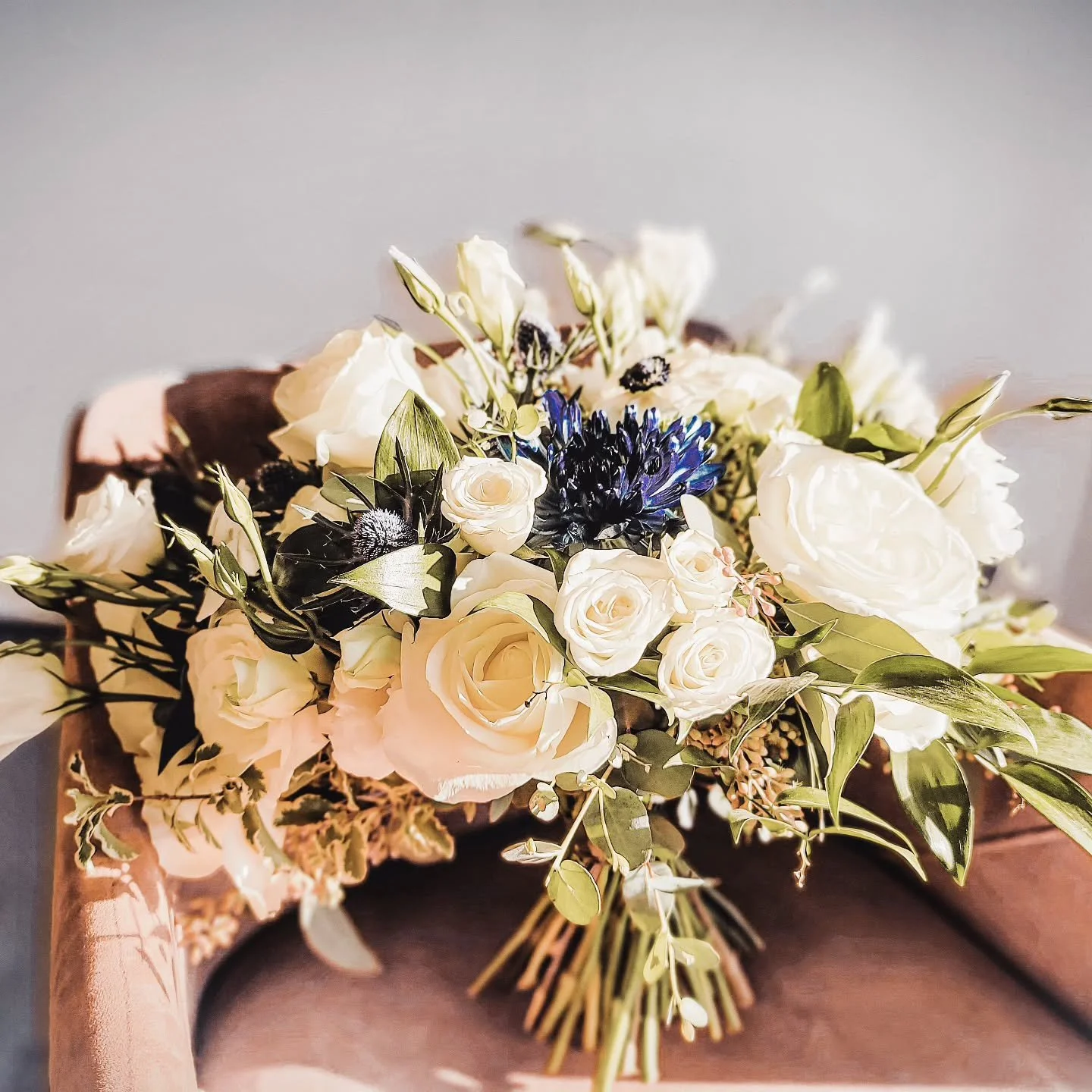 A bouquet as timeless as love itself. 💙 Soft whites, lush greens, and a pop of deep navy for the perfect elegant touch. 🌿 Designed to complement a beautiful love story. 

#TheFlowerCrown #LuxuryWeddingFlorals #ModestoFlorist #CentralValleyWeddings 