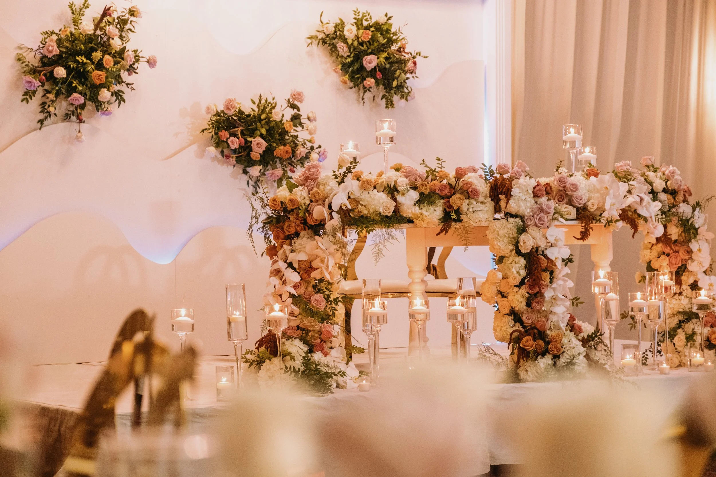 luxurious sweet heart table with cascading flowers and candles