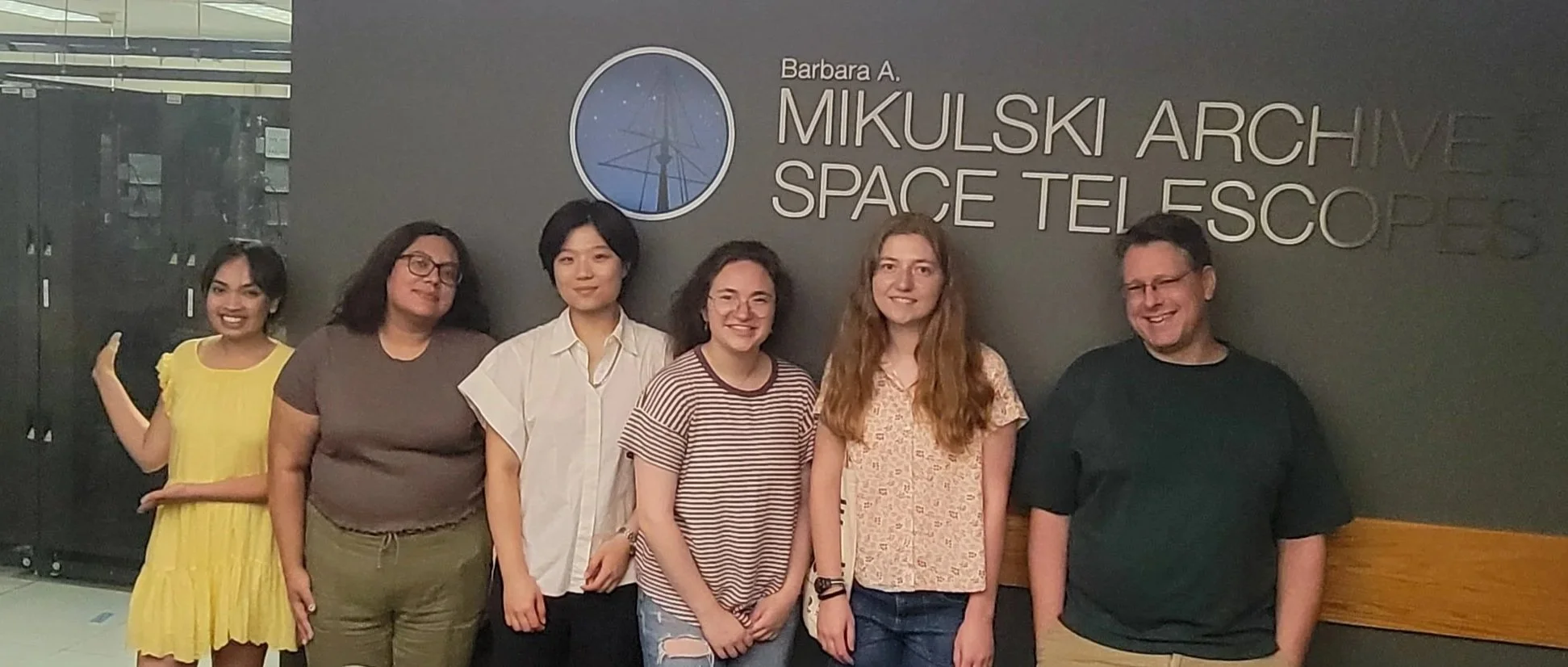 Summer students and Observatory Manager Jonathan Kemp in front of the Mikulski Archive for Space Telescopes (Go MAST!)