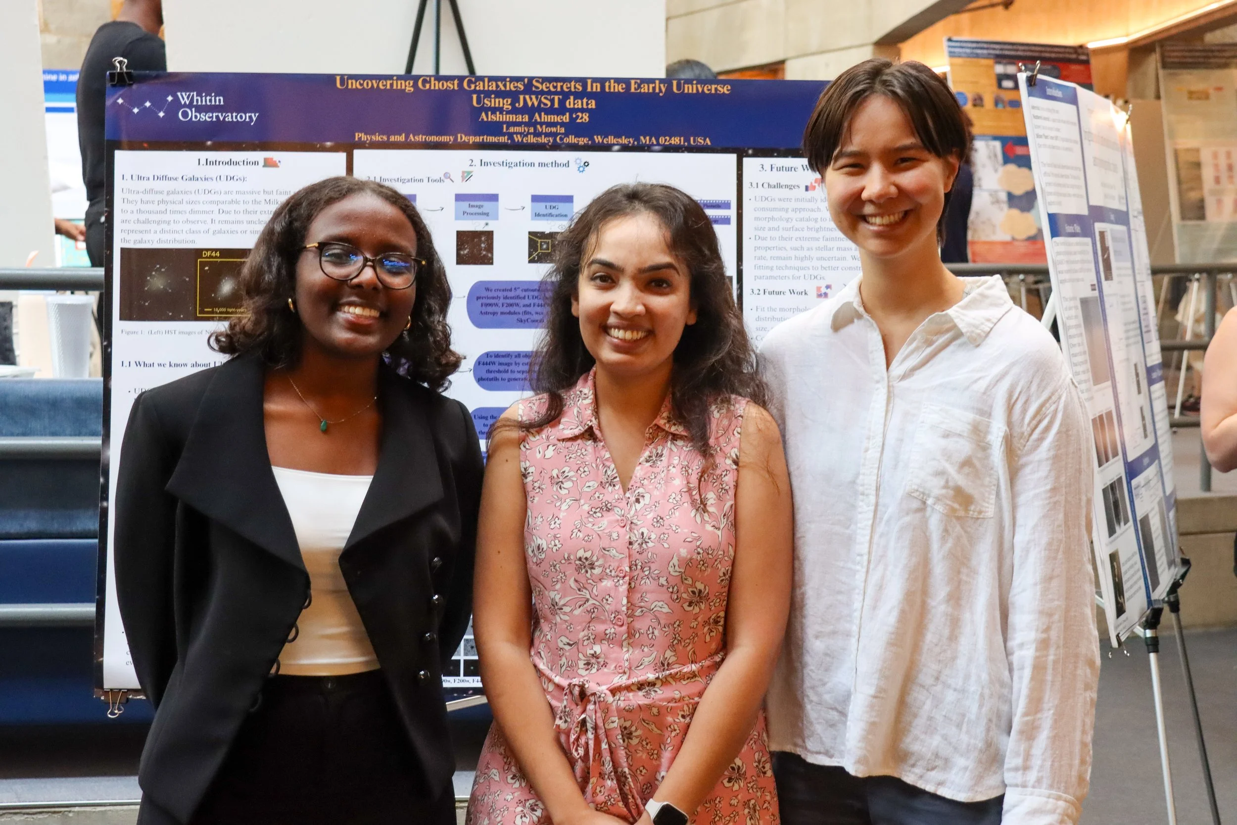 Alshimaa Ahmed'28 in front of her Tanner 2025 poster presenting her summer research, joined by research partner Fiona Boutelle from Bard College