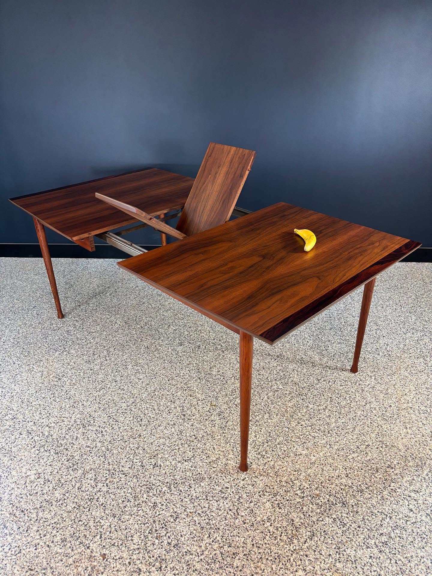 Restored vintage 1960&rsquo;s Mid Century Modern Stanley Linear Precision walnut &amp; rosewood butterfly leaf surfboard dining table. ⁣
⁣
Pretty rare. Lovely legs and warm veneer. Seats four to six. Giddy up. ⁣
⁣
Banana for scale. ⁣
⁣
72 L x 40 D x 