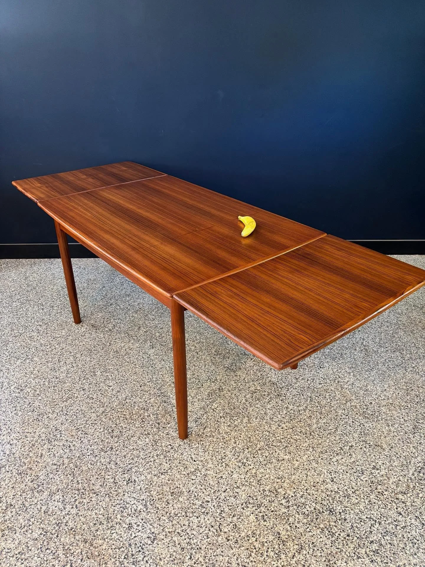 Restored vintage 1970&rsquo;s Mid Century Danish Modern teak draw leaf dining table. ⁣
⁣
Always a crowd pleaser, these tables. Seats six. Giddy up. ⁣
⁣
Banana for scale. ⁣
⁣
84.5 W x 32.5 D x 29.5 H with leaves out⁣
48 W with leaves in ⁣
Apron 23.75 