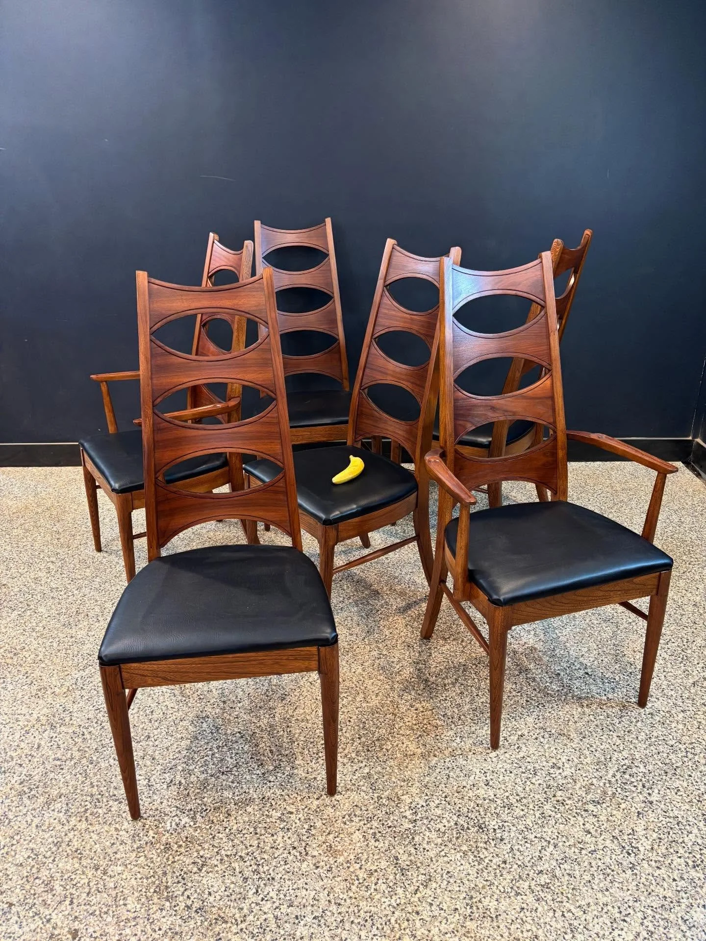 Set of six restored vintage 1960&rsquo;s Mid Century Modern Kent Coffey Perspecta walnut high back cat eye dining chairs. ⁣
⁣
Four sides and two captains. ⁣
⁣
Fully restored, joints are tight, and seats have been recovered in black vinyl. ⁣
⁣
Banana 