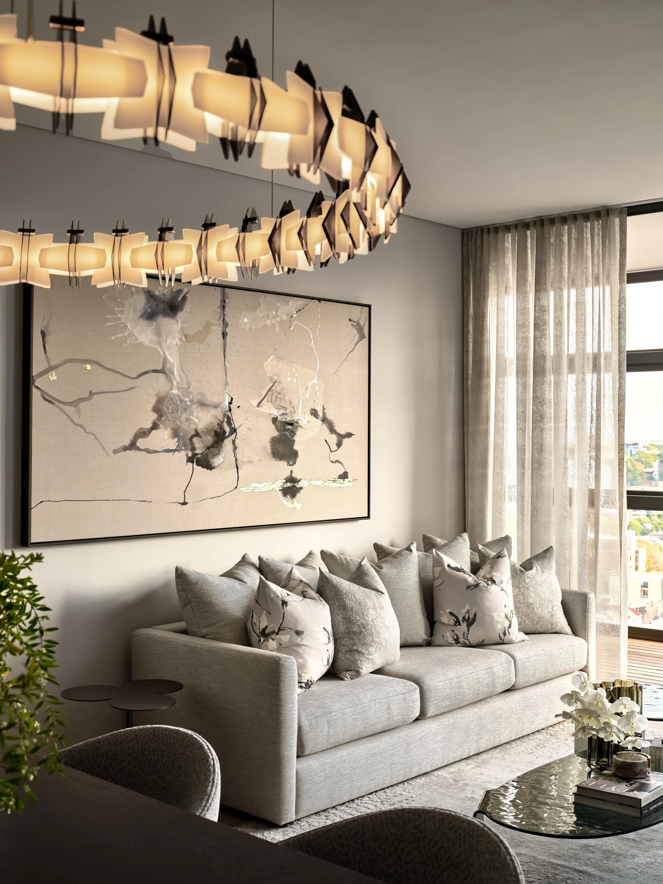 Luxury penthouse living room with statement chandelier by Mandy Alice, Byron Bay interior designer — bespoke furnishing, Chippendale Sydney.