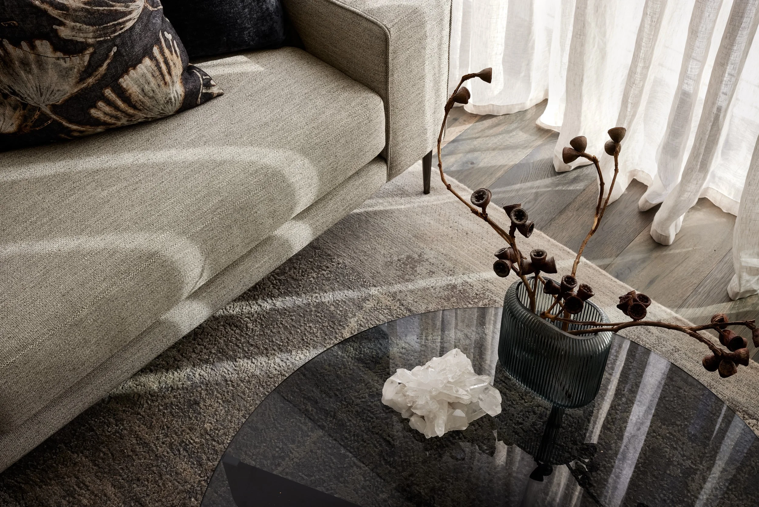 Close-up of hand-selected textiles and neutral scatter cushions, showcasing the layered detail of a Gold Coast interior design project