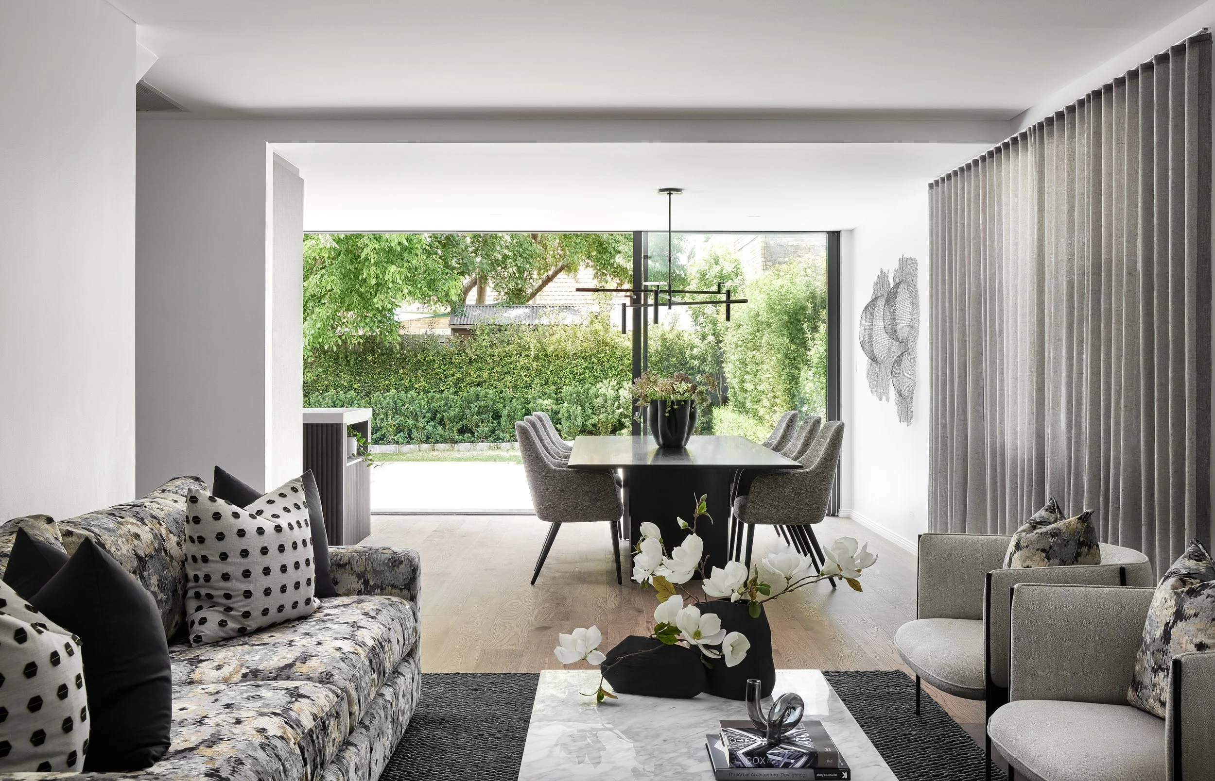 Open plan dining and informal living area by Mandy Alice, Byron Bay interior designer — bespoke furnishing and considered styling for a full home renovation in Mosman, Sydney.