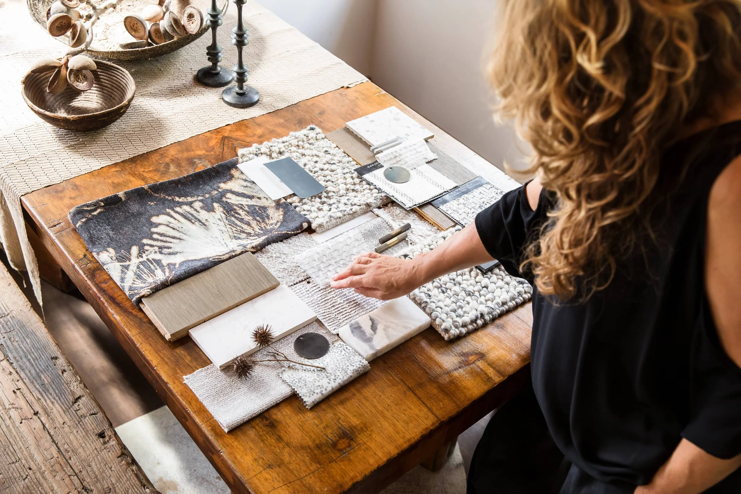 Mandy Alice, Byron Bay interior designer, reviewing material and finish selections at her studio in the Northern Rivers