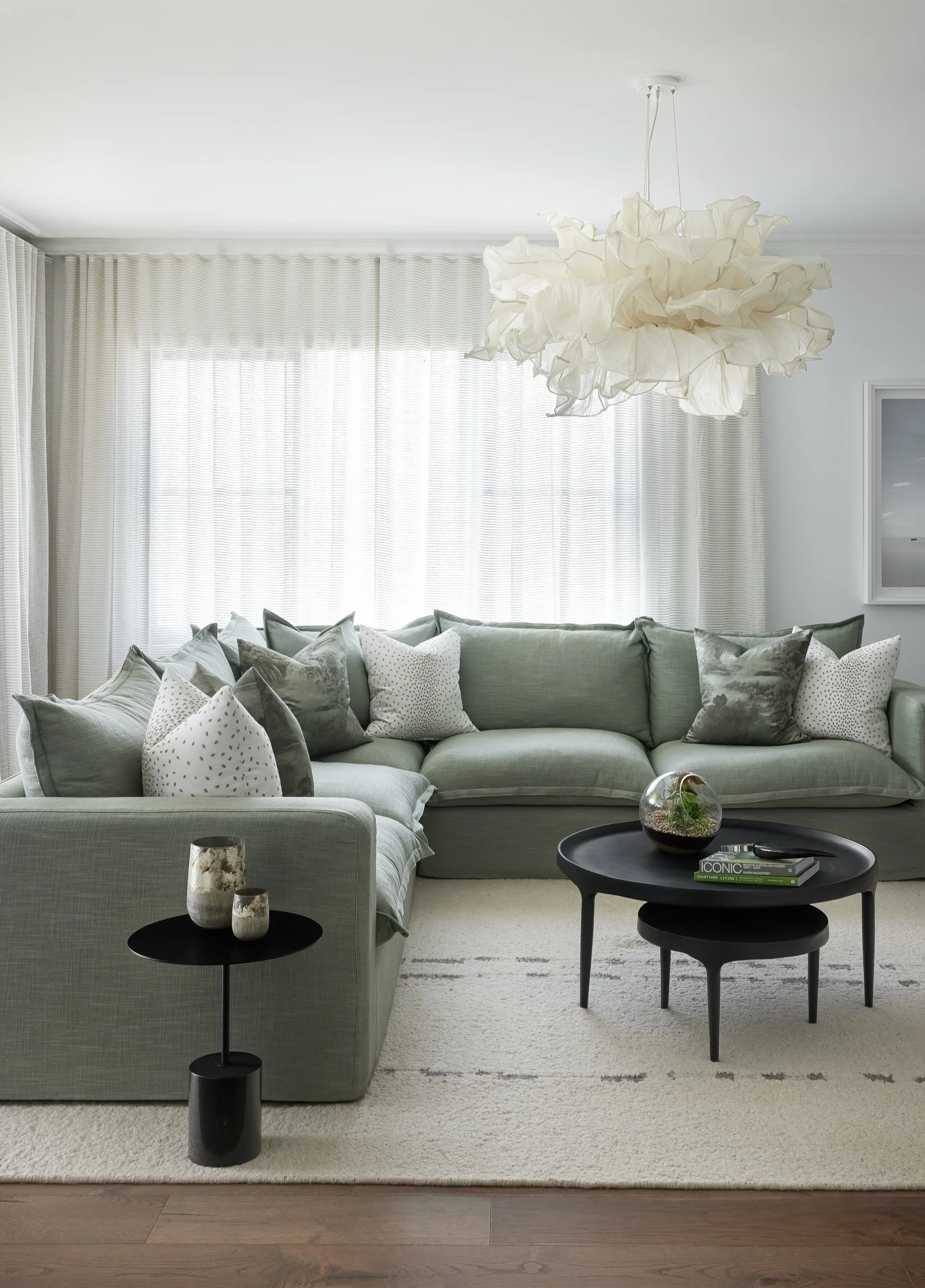 Luxury residential interior design services featuring an organic modern living area with sage green tones, curated furniture, and bespoke lighting by Mandy Alice in Byron Bay and the Gold Coast