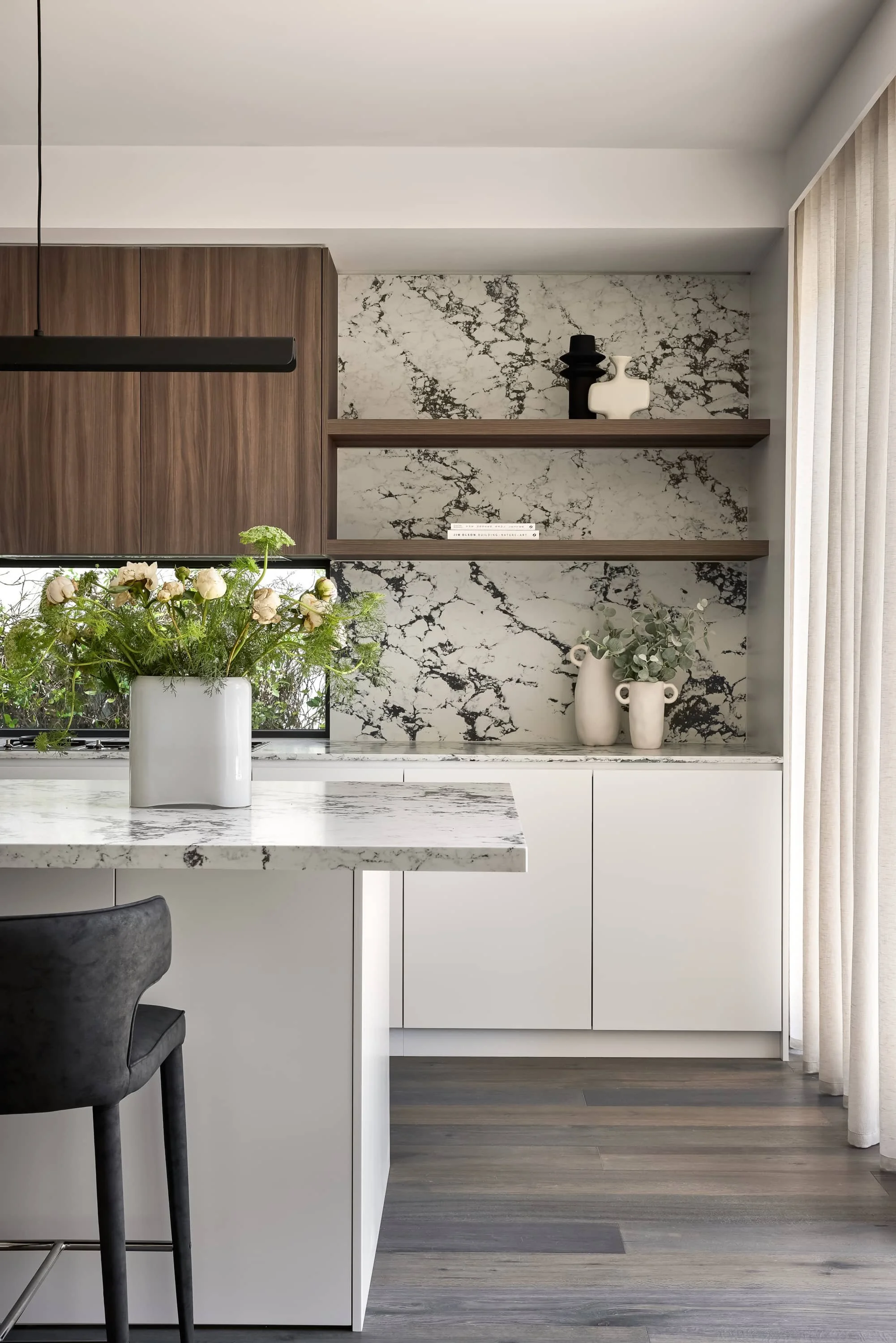 High-end kitchen design with marble countertop and white cabinetry by Mandy Alice Interior Design Byron Bay