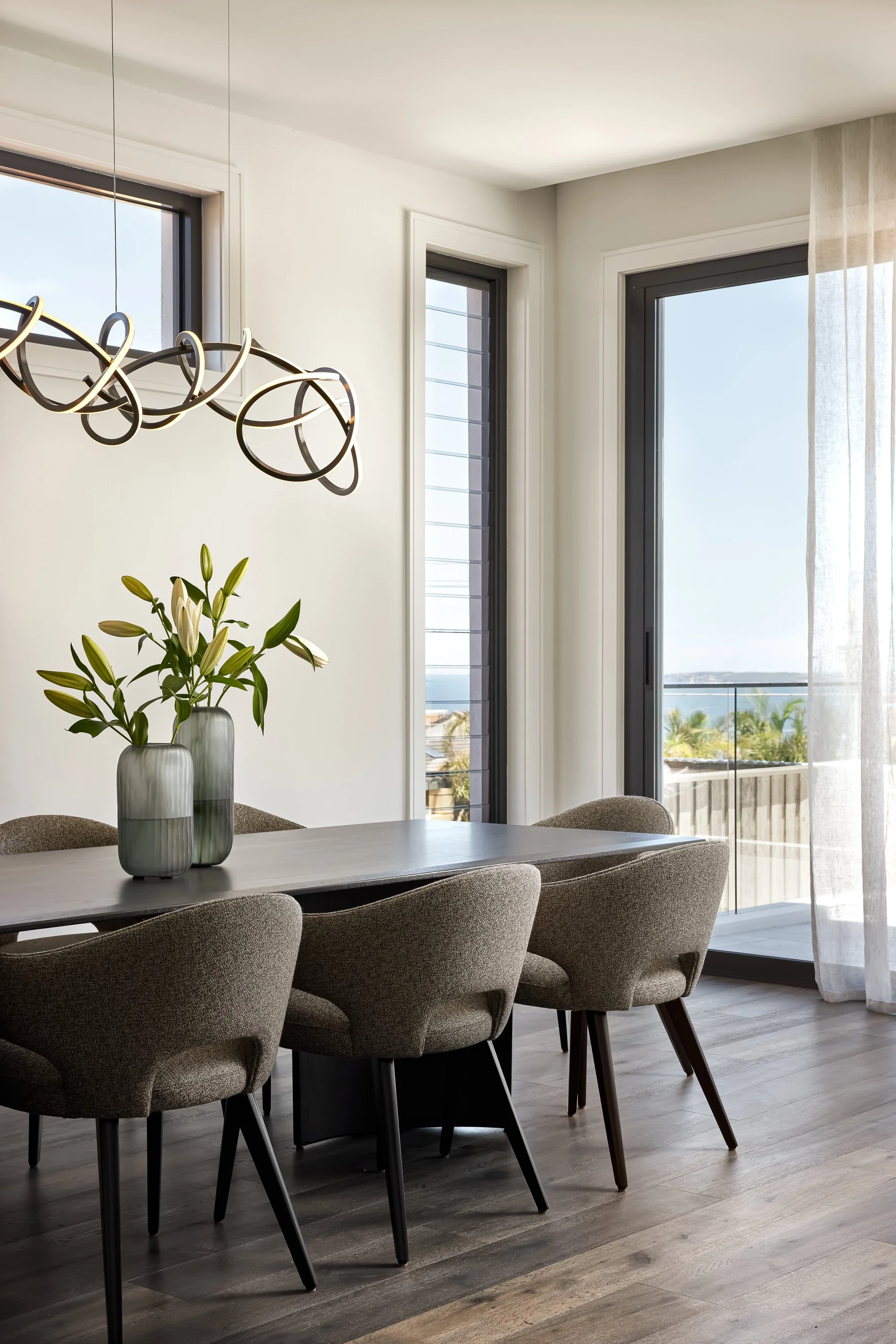 Formal dining room with ocean views and statement pendant by Mandy Alice, Byron Bay interior designer, Dover Heights Sydney.

