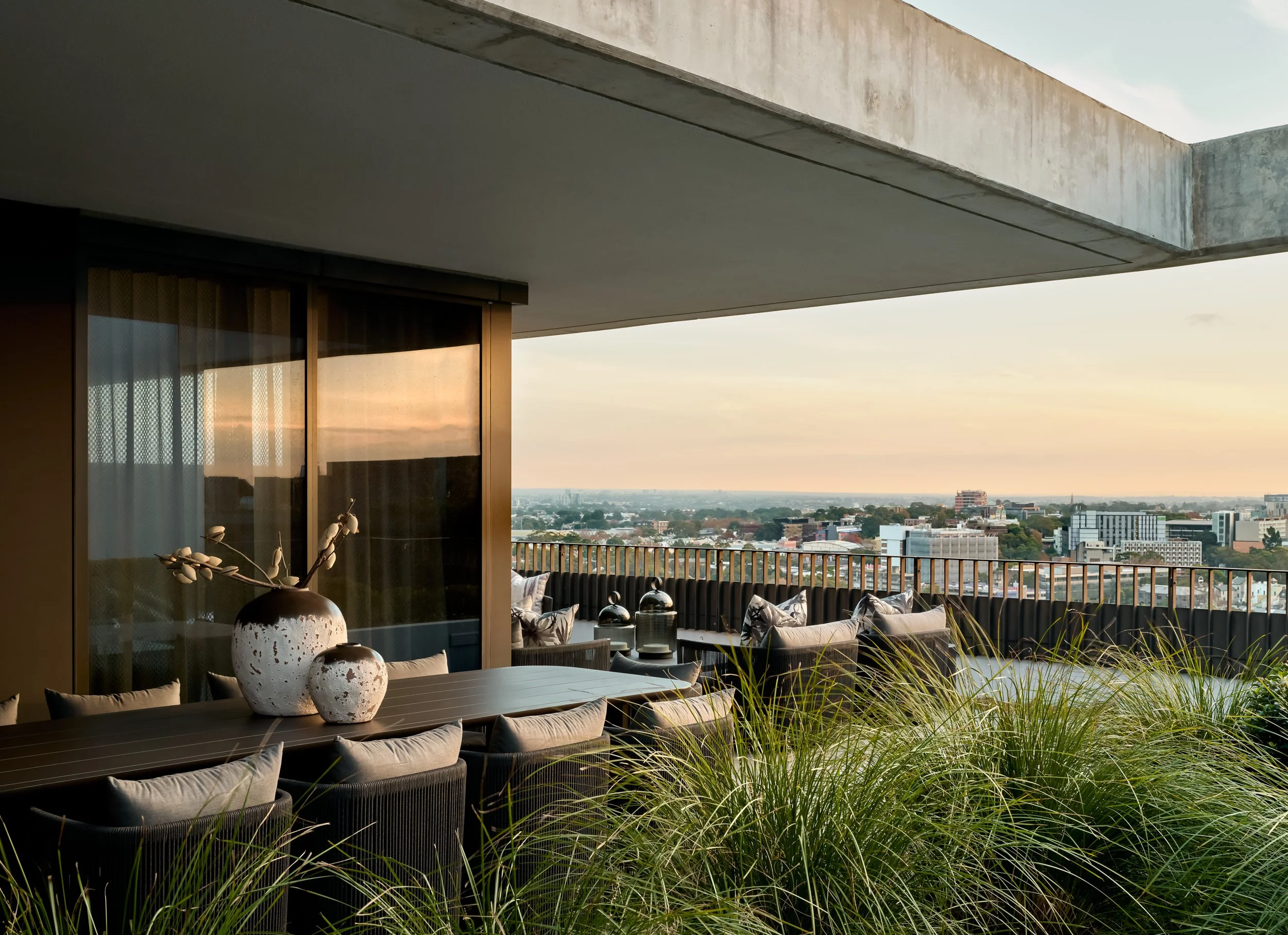 Luxury penthouse outdoor terrace at dusk by Mandy Alice, Byron Bay interior designer — curated styling with Sydney skyline views.