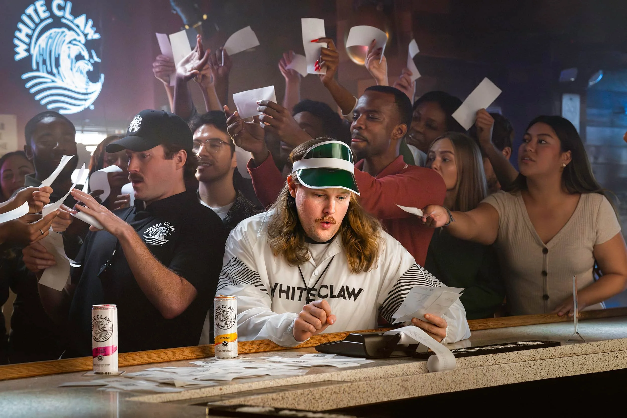 White Claw campaign with bartender and crowd at a busy bar, lifestyle commercial photography