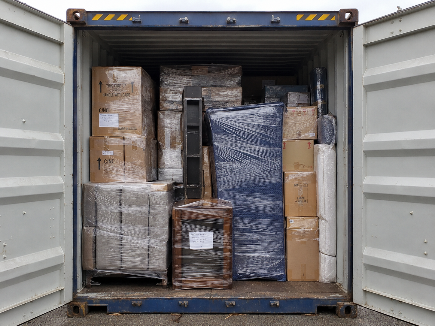 Household goods and personal belongings securely loaded inside a shipping container for export shipping to Nigeria.