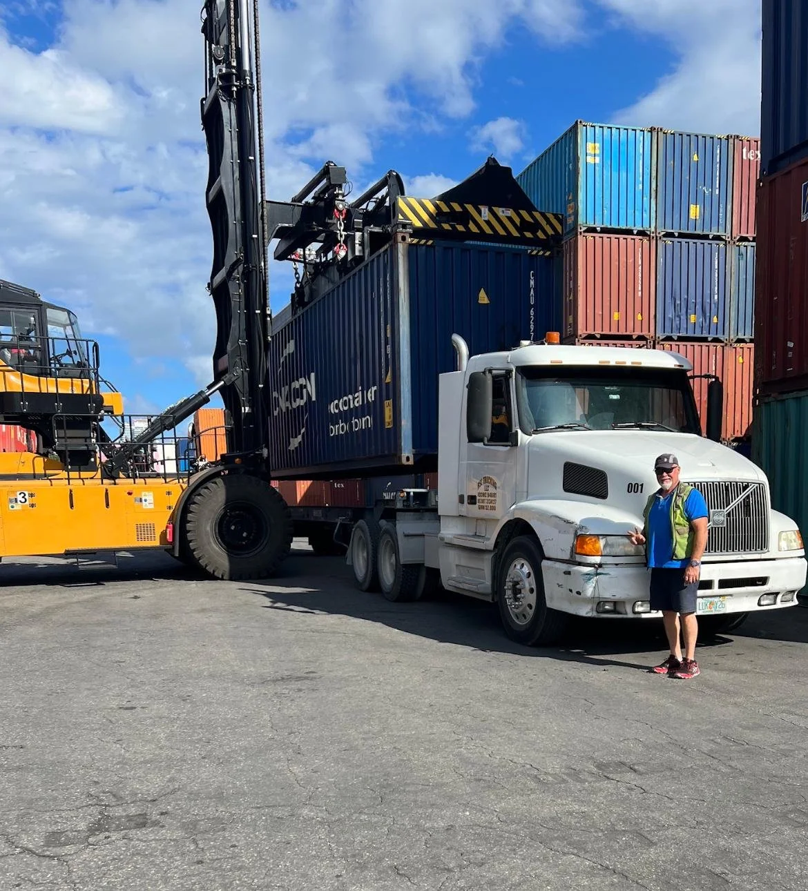 Shipping container being delivered at a port terminal for international container shipping