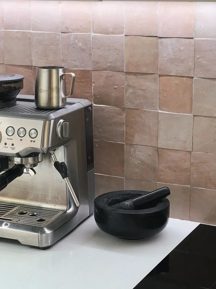 Handmade terracotta Zellige tile kitchen splashback behind an espresso machine setup