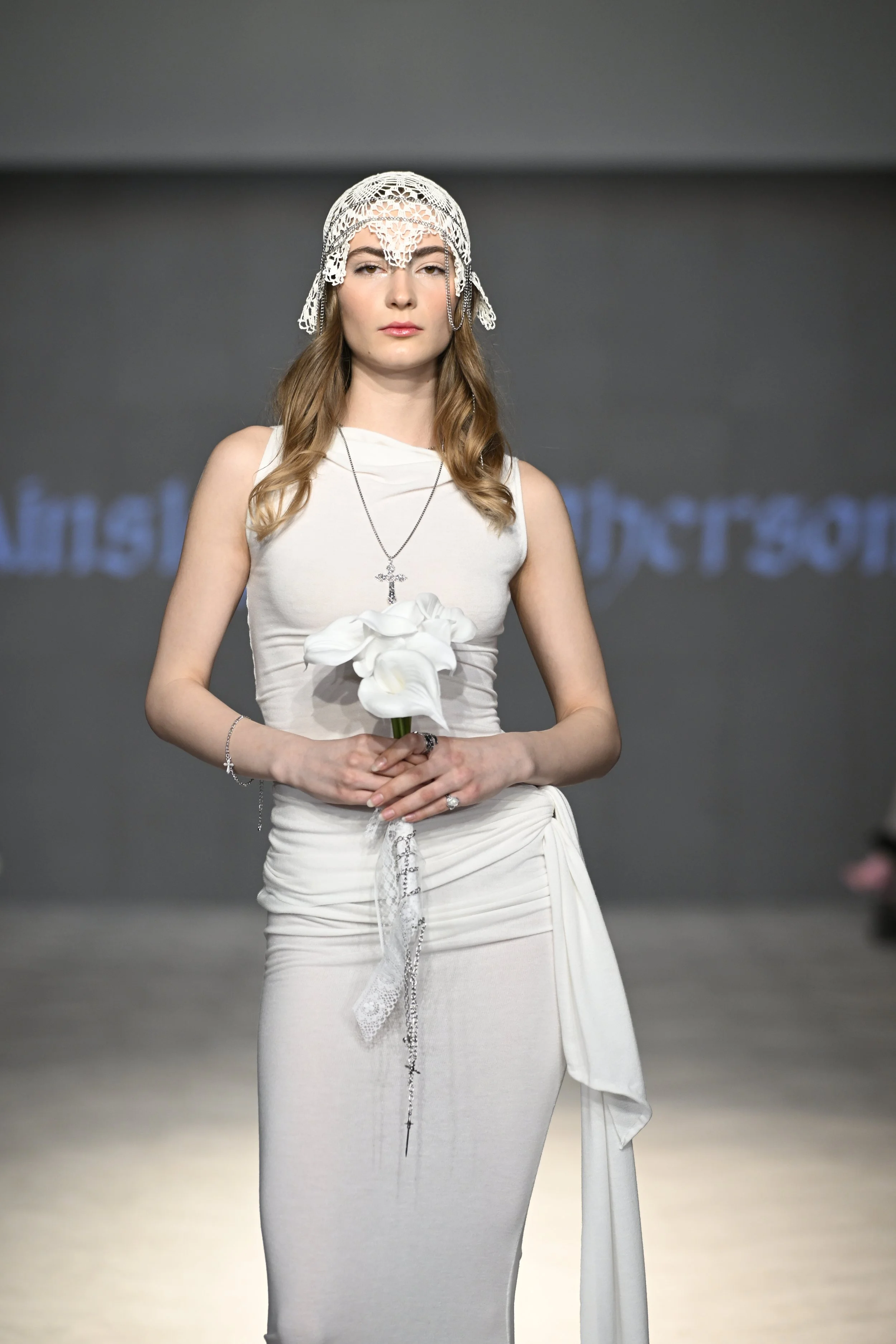 Michaela wears a ruched cowl neck wedding dress with draped ties at the hip. She wears handmade headpiece of vintage lace and chain.