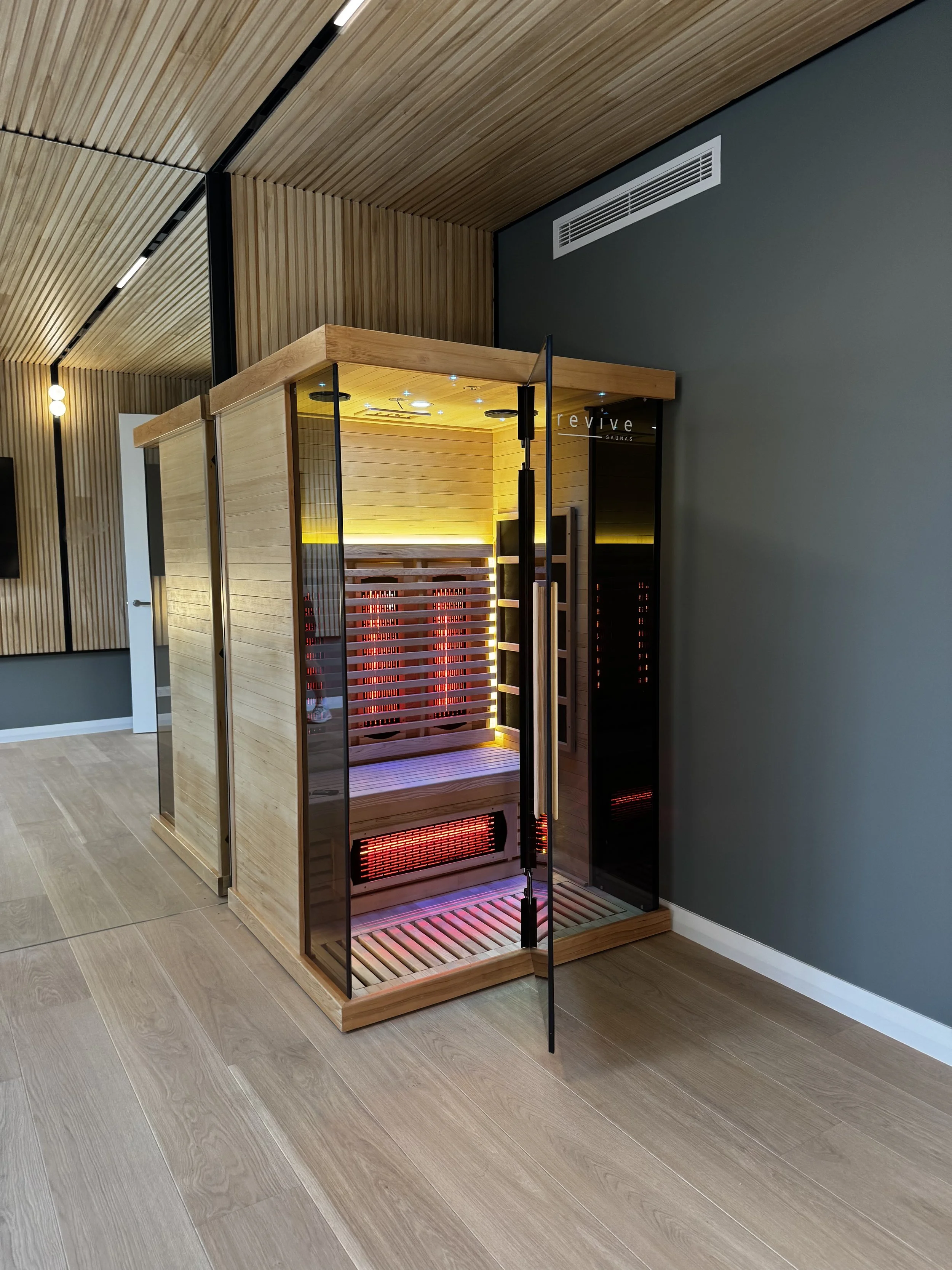 Infrared home sauna Perth setup in a modern wooden room with glass door