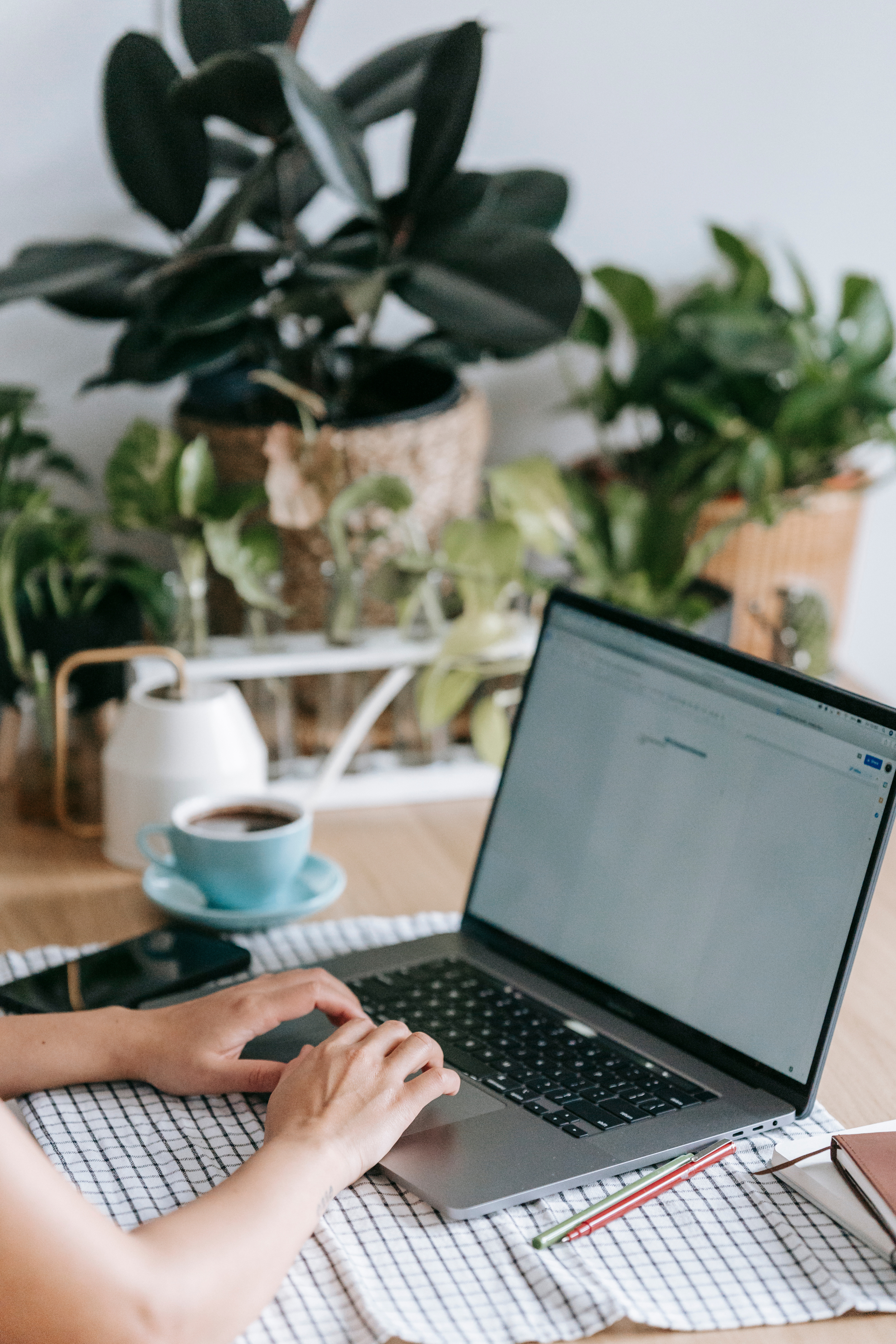 The person on her laptop is editing her content reprposing to post on her social media to promote her podcast episode.