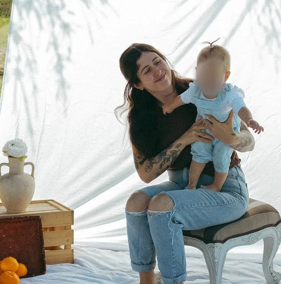 creator of mud buddies holding baby/toddler on lap