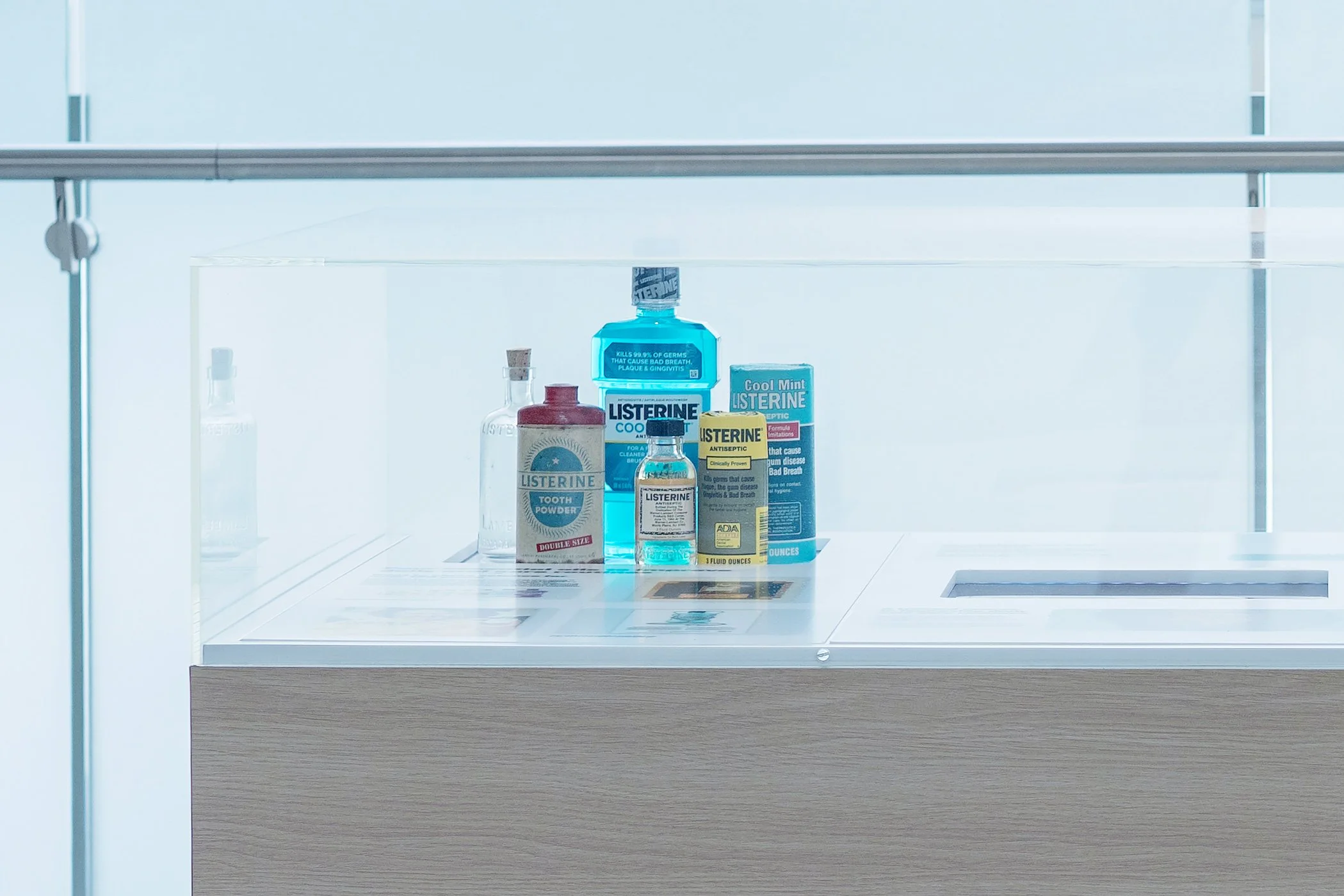 Shelves with various bottles and boxes of Listerine mouthwash and dental products in a clean, bright setting.